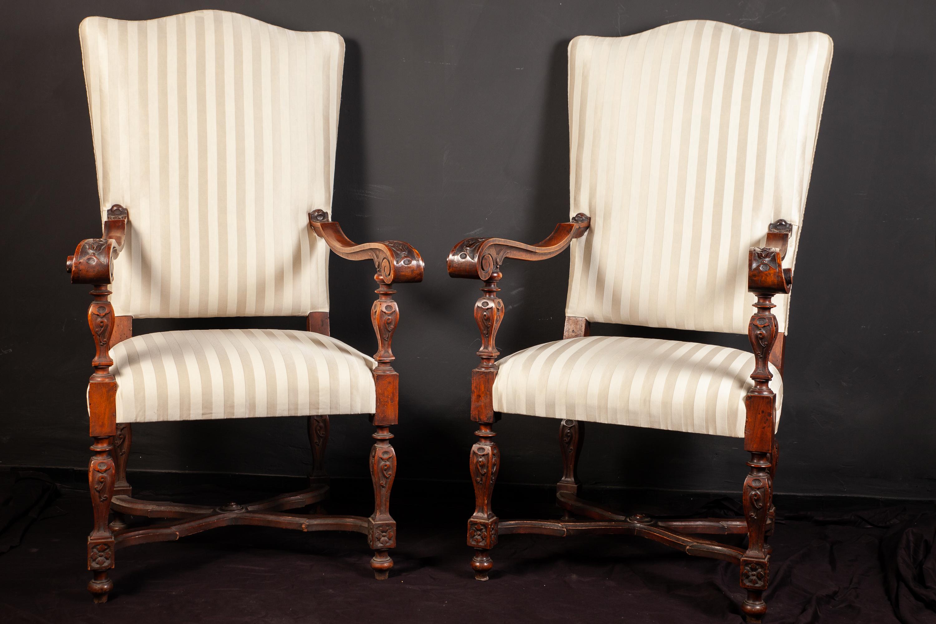 Pair of elegant Italian 19th century walnut finely carved armchairs with a white striped upholstery.
Measures: 130 x 60 x 50.