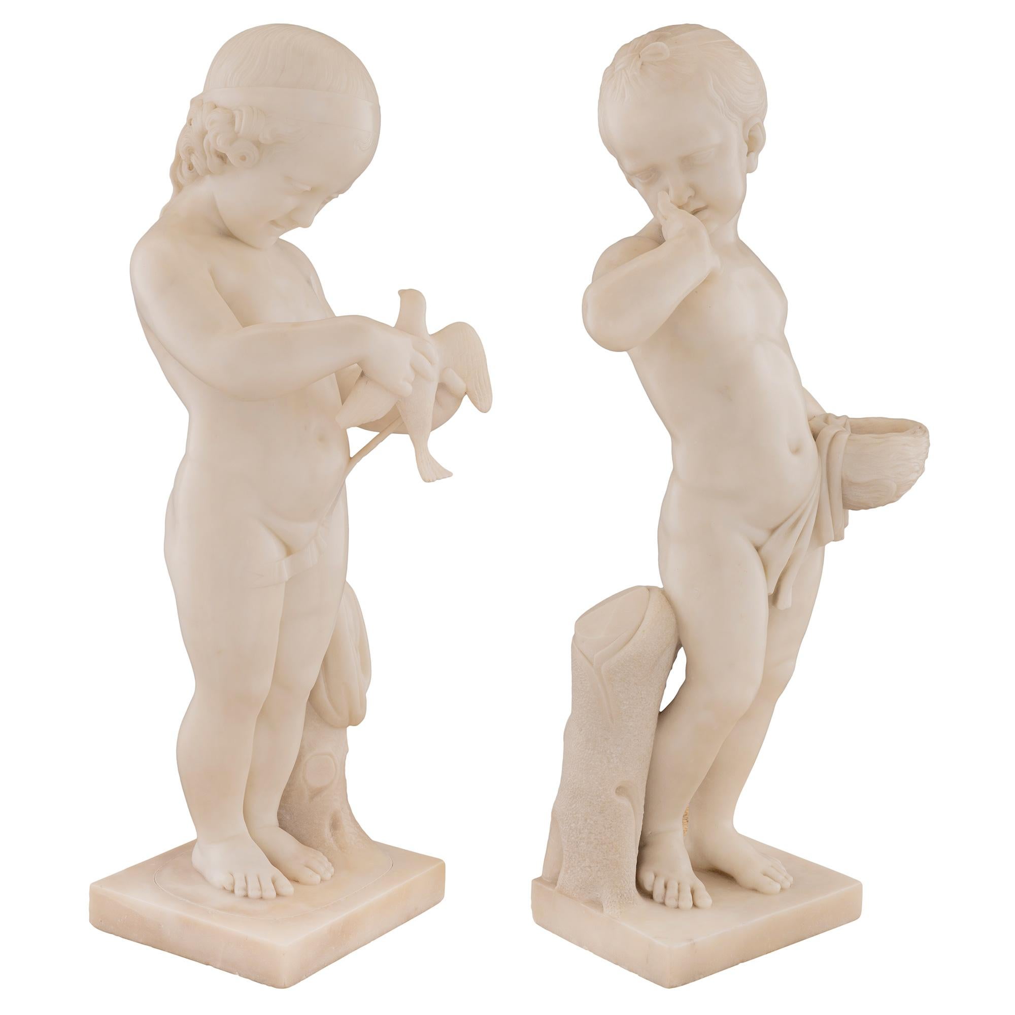 A most charming and extremely high quality pair of Italian 19th century white Carrara marble statues. Each statue is raised by a square base with a wonderfully executed ground like design and a striking tree trunk. Above are the richly carved