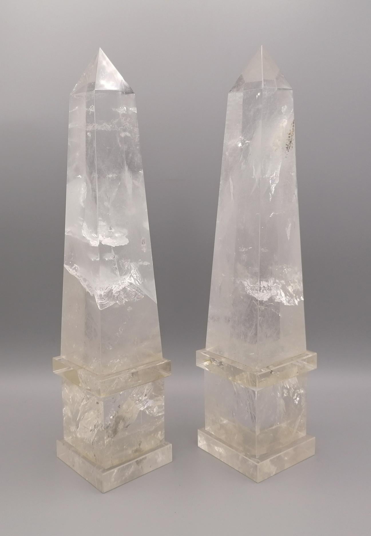 A gorgeous and decorative pair of Mid-Century Modern Italian rock crystal quartz hand carved and hand-polished obelisks. Each obelisk is made of a natural rock crystal quartz which has been hand-diamond cut and hand-polished with the finest detail.