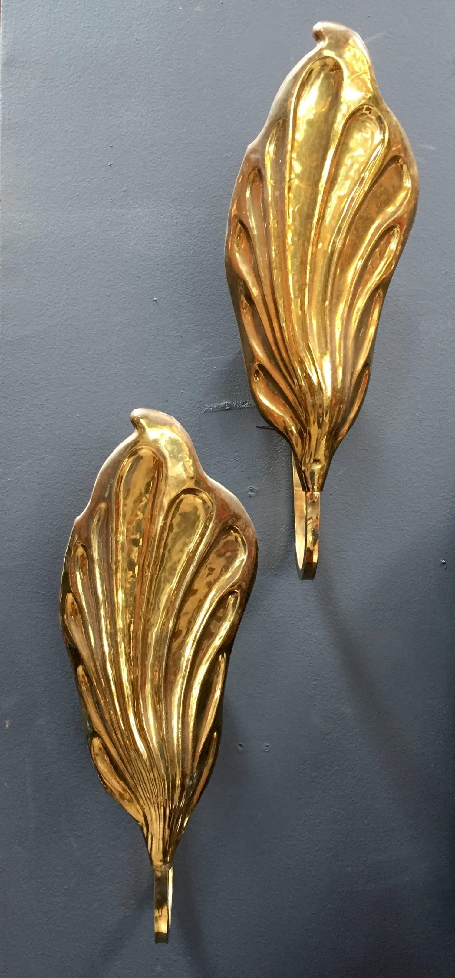 A pair of Tommaso Barbi wall lights in brass in the shape of leave. Italy, 1970s. Italian designer Tommaso Barbi is best known for whimsical furniture featuring organic forms, particularly brass leaf-shaped lamps.
AD 
