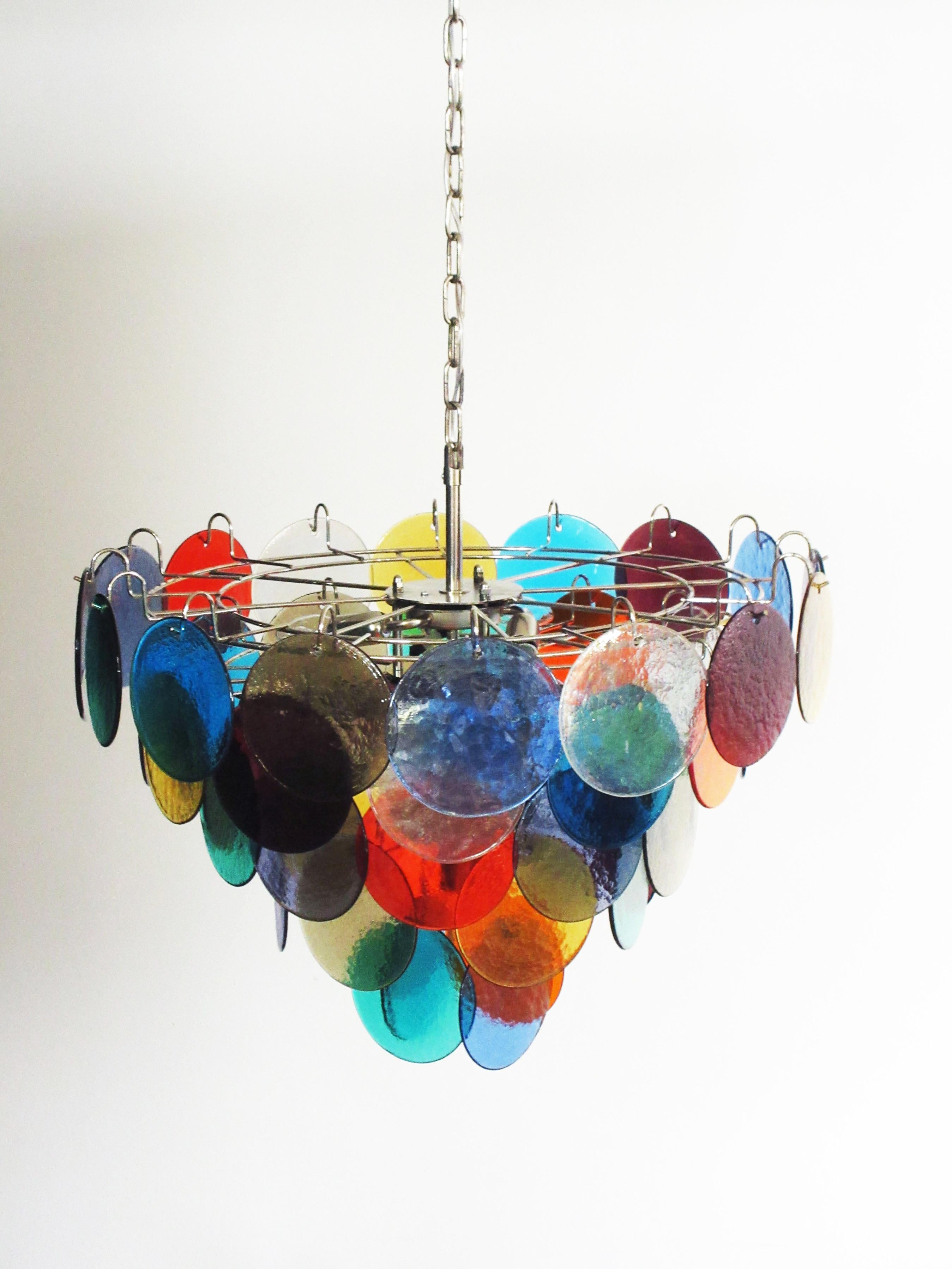 Each chandelier has 50 Murano multicolored glass disks. The glasses are now unavailable, they have the particularity of reflecting a multiplicity of colors, which makes the chandelier a true work of art. Nickel metal frame.
Period:
