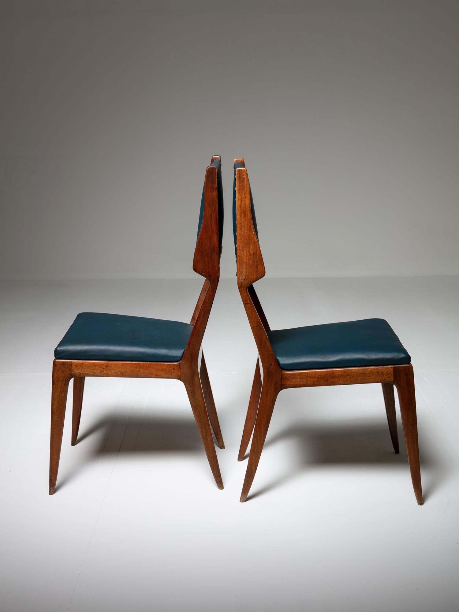 High-back chairs with sleek walnut frame.