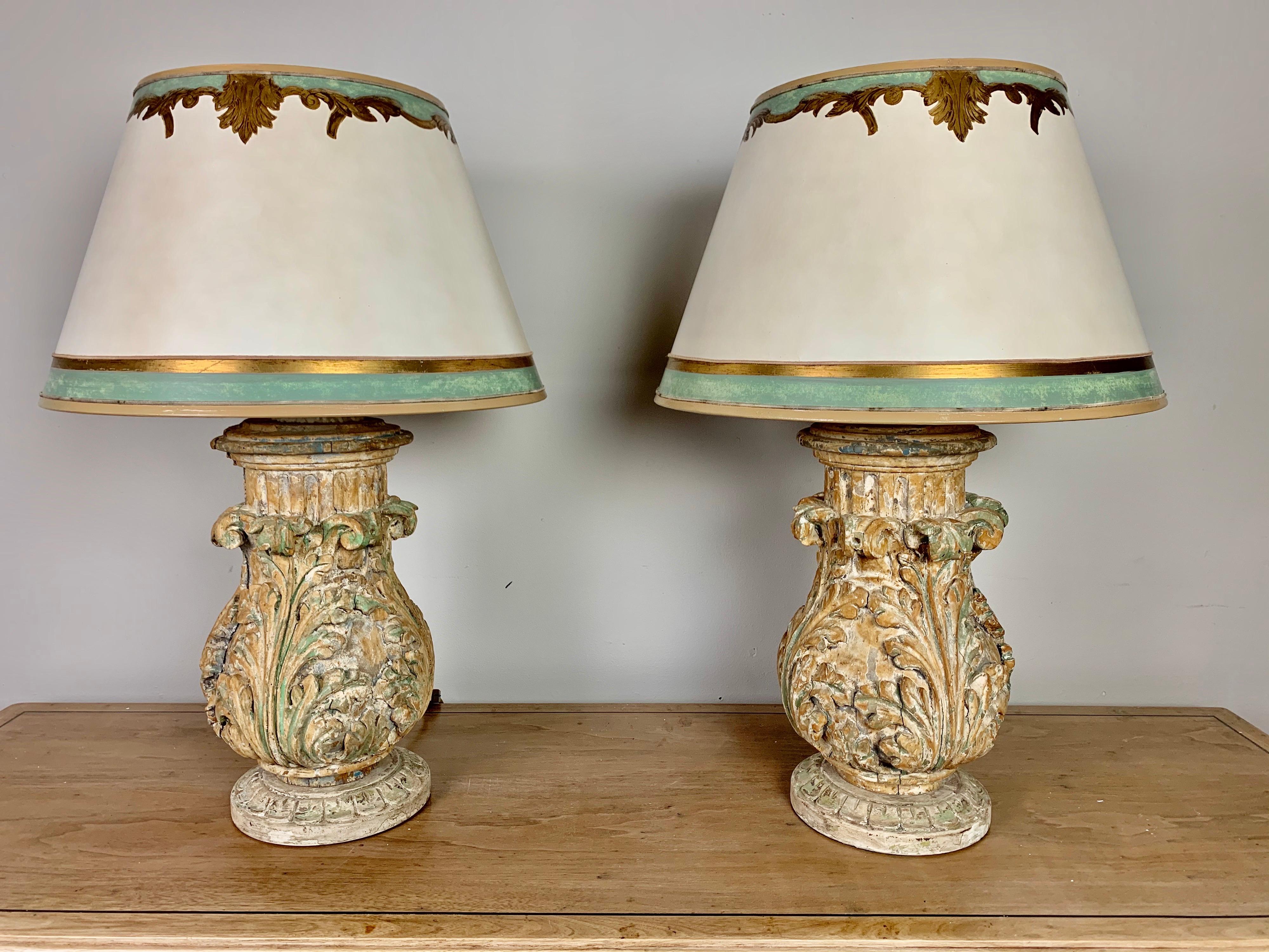 Pair of custom lamps made with 19th century hand carved acanthus leaf carvings mounted into lamps. The lamps are crowned with custom hand painted parchment shades that match to perfection. The lamps are newly wired and ready to plug in.