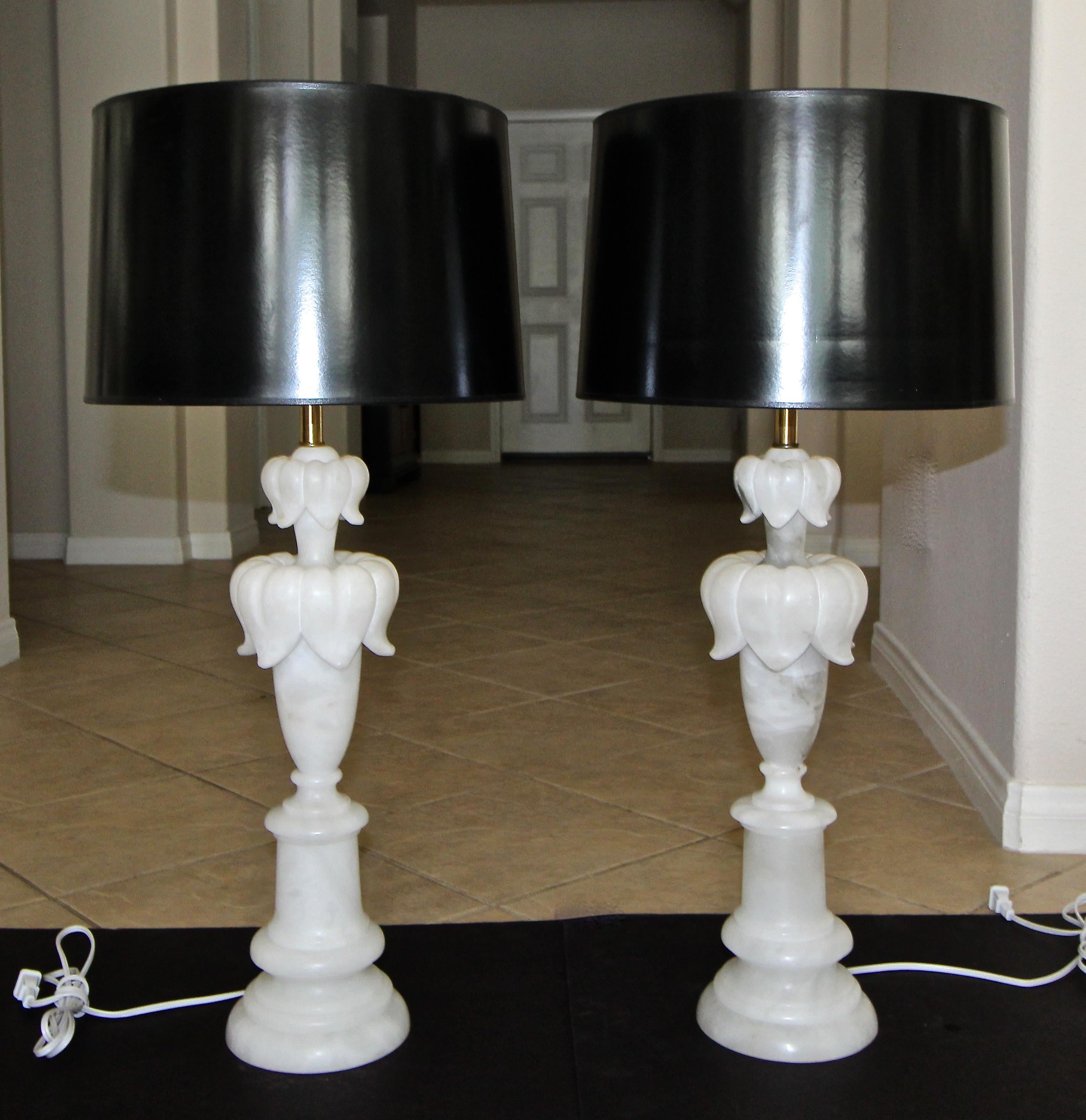 Pair of Italian neoclassic style alabaster table lamps with flower leaf detailing and brass fittings. Newly rewired with 3 way socket and white cord. Shades not included for photography purposes only.