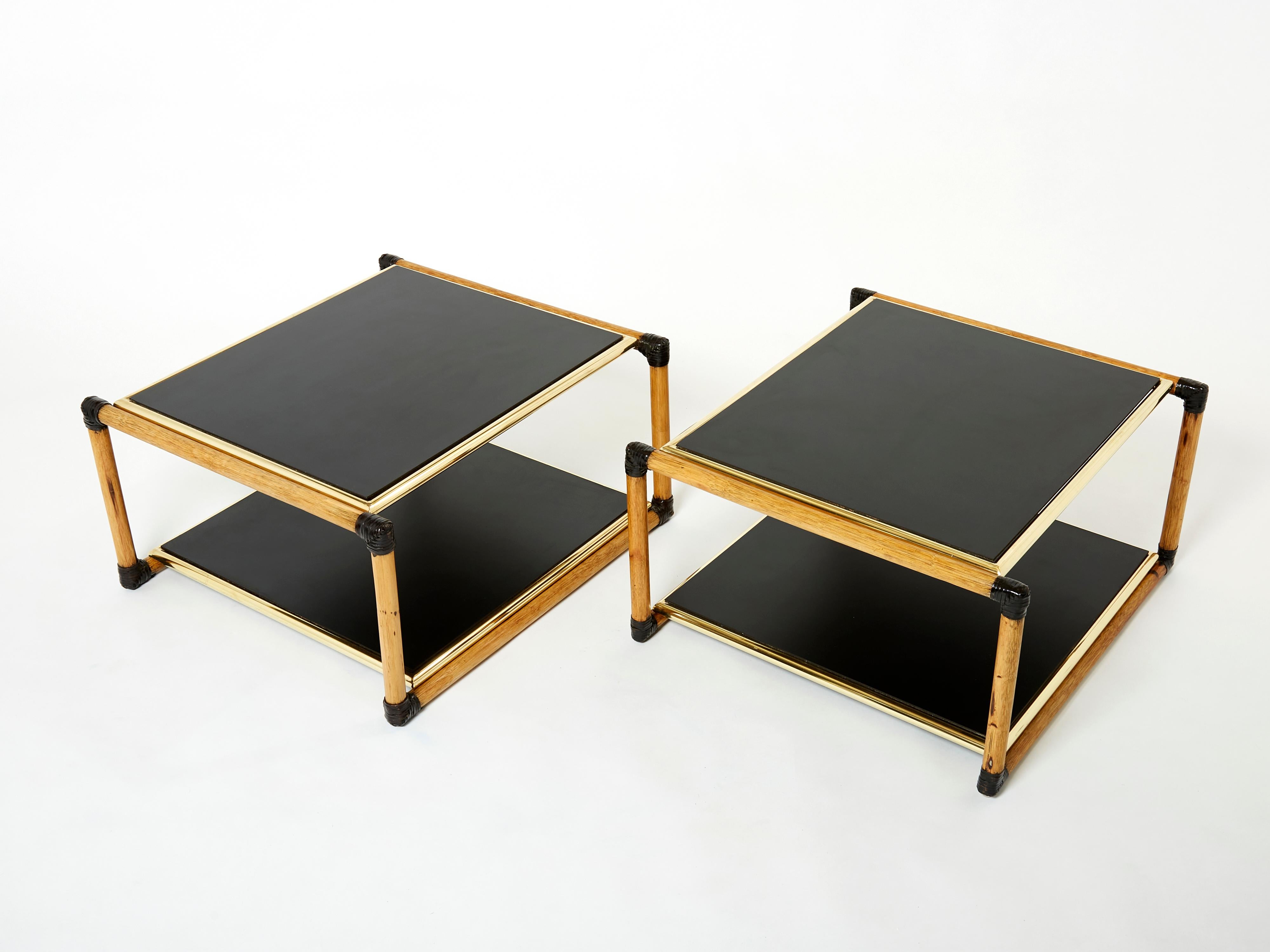 Natural bamboo and brass as the chief materials create a summery, organic aesthetic in these 1970’s two-tier side tables, or end tables, while the black wood tops are strong, adding the chic touch. The brass details are lovely examples of