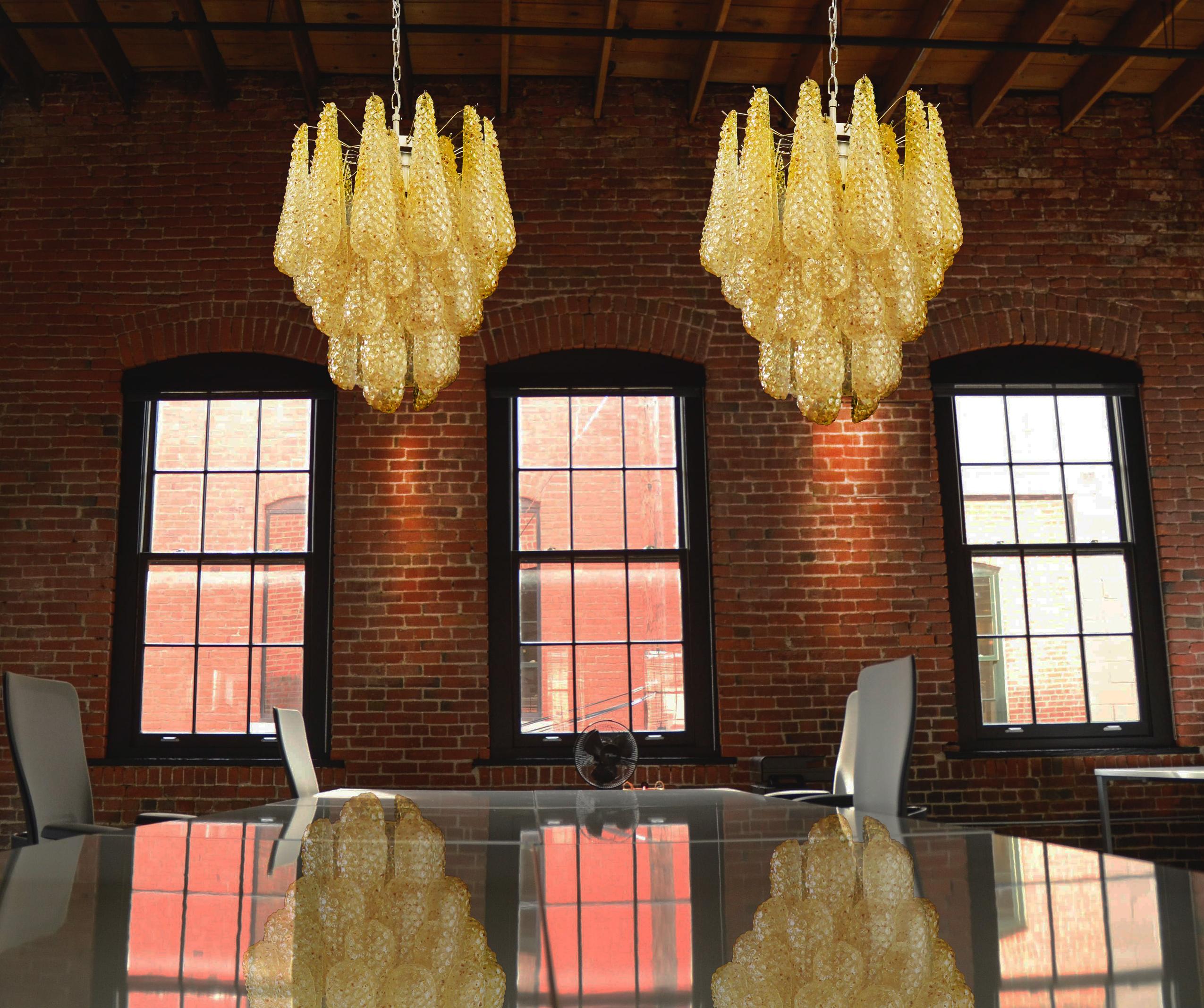 Pair of Italian vintage Murano chandeliers made by 41 glass petals (amber crystal, smooth outside, with crystal trasparent and amber powder and then rough inside.) in a chrome frame.
Period: Late 20th century
Dimensions: 49,20 inches (125 cm)