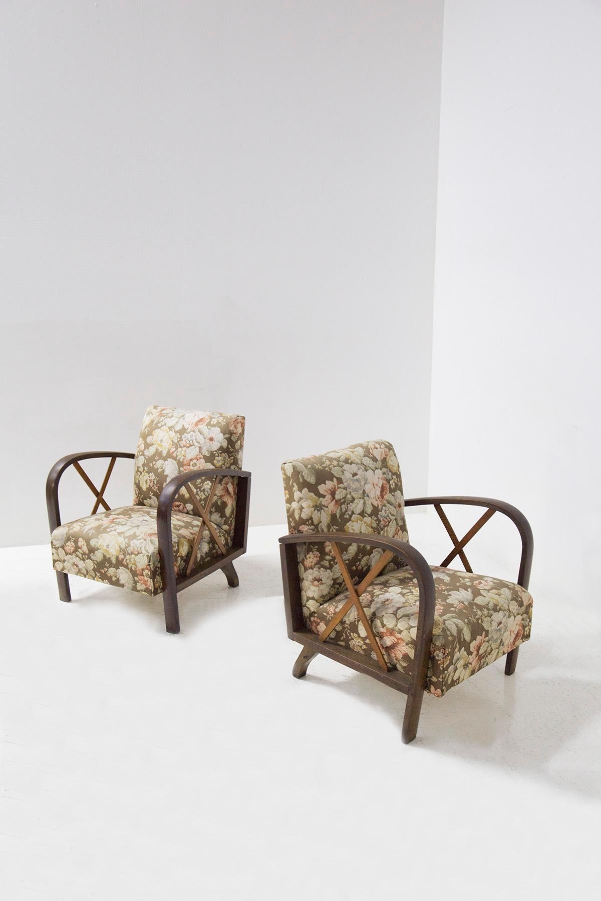 Elegant pair of Italian armchairs attributed to Paolo Buffa from the 1950s. The armchairs are in its original state of the time, also the fabric is original of the time with floral weave. The frame is made of wood and its peculiarity is in its