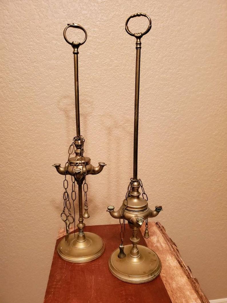 A lovely pair of elegant and interesting 19th century brass Lucerna oil lamps from Italy. Commonly used throughout the Mediterranean from Spain to India and Russia 

The similarly styled antique pair, circa 1820s, feature a decorated top ring,