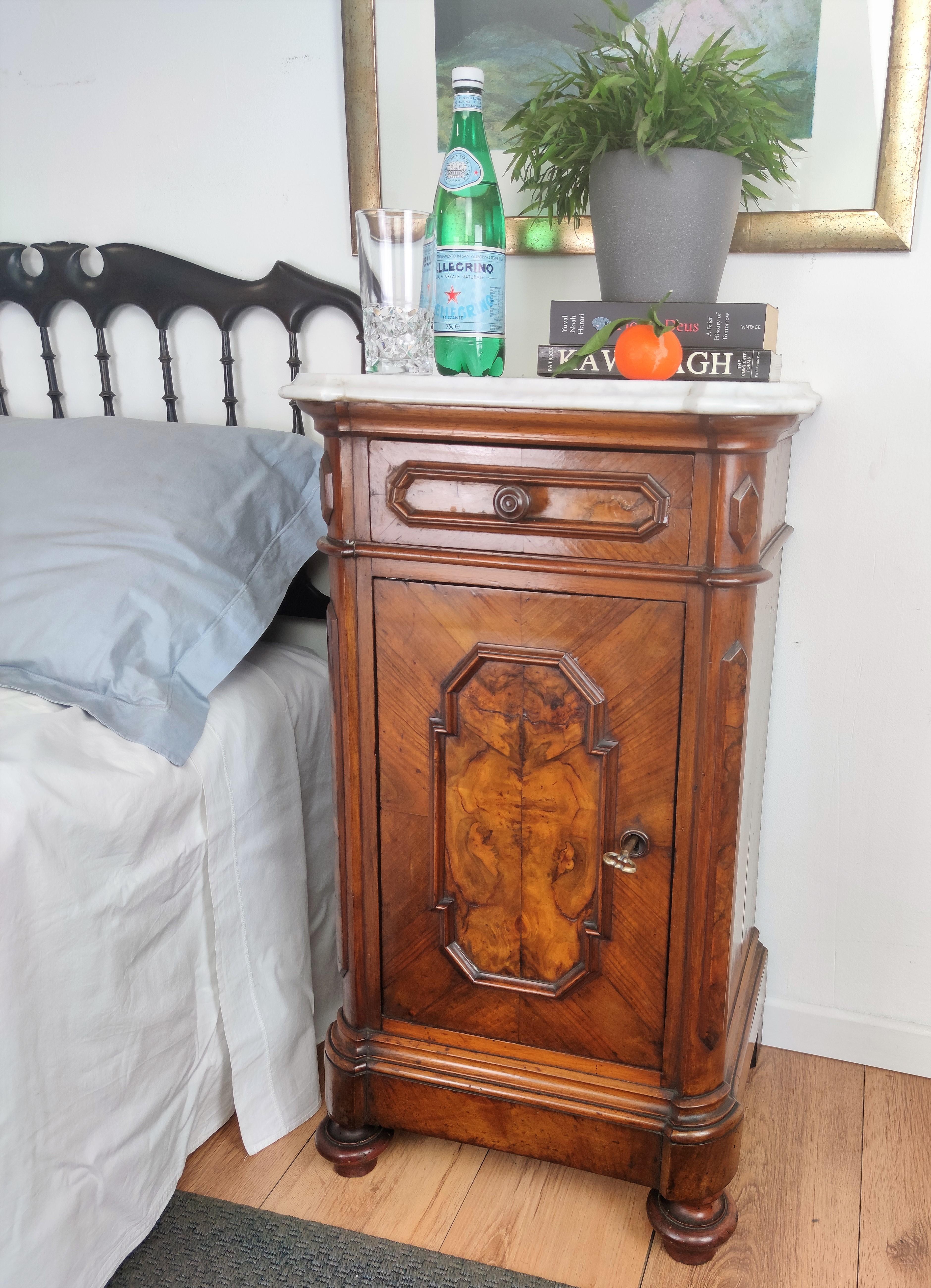 Pair of lovely antique Italian night stands or side tables with greatly carved doors and drawers and white beveled and shaped marble top. The nightstands have a door and drawer that are beautifully crafted and framed in the front with the typical