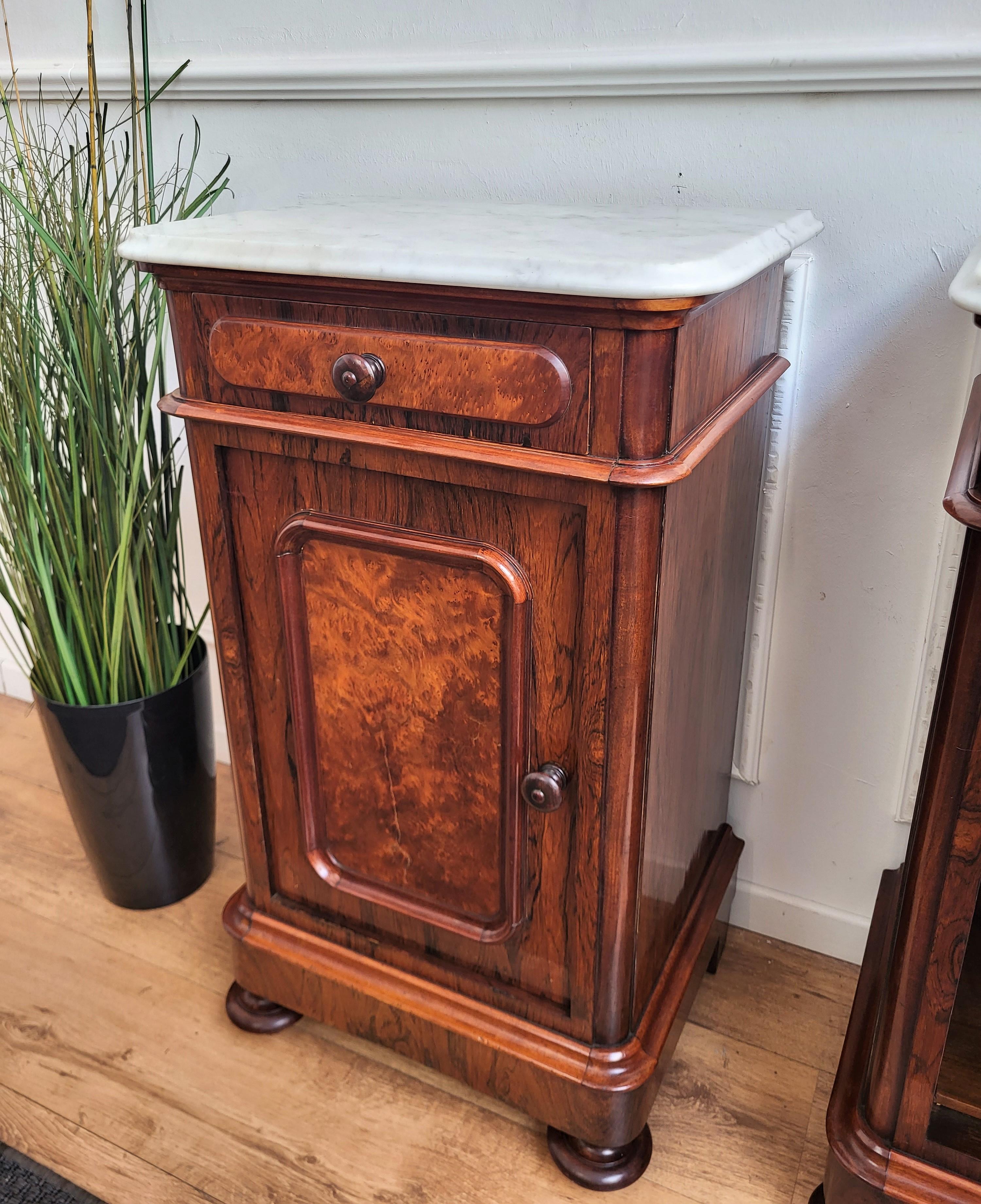 Pair of lovely antique Italian night stands or side tables with greatly carved doors and drawers and white beveled and shaped white carrara marble top. The nightstands have a door and drawer that are beautifully crafted and framed in the front with