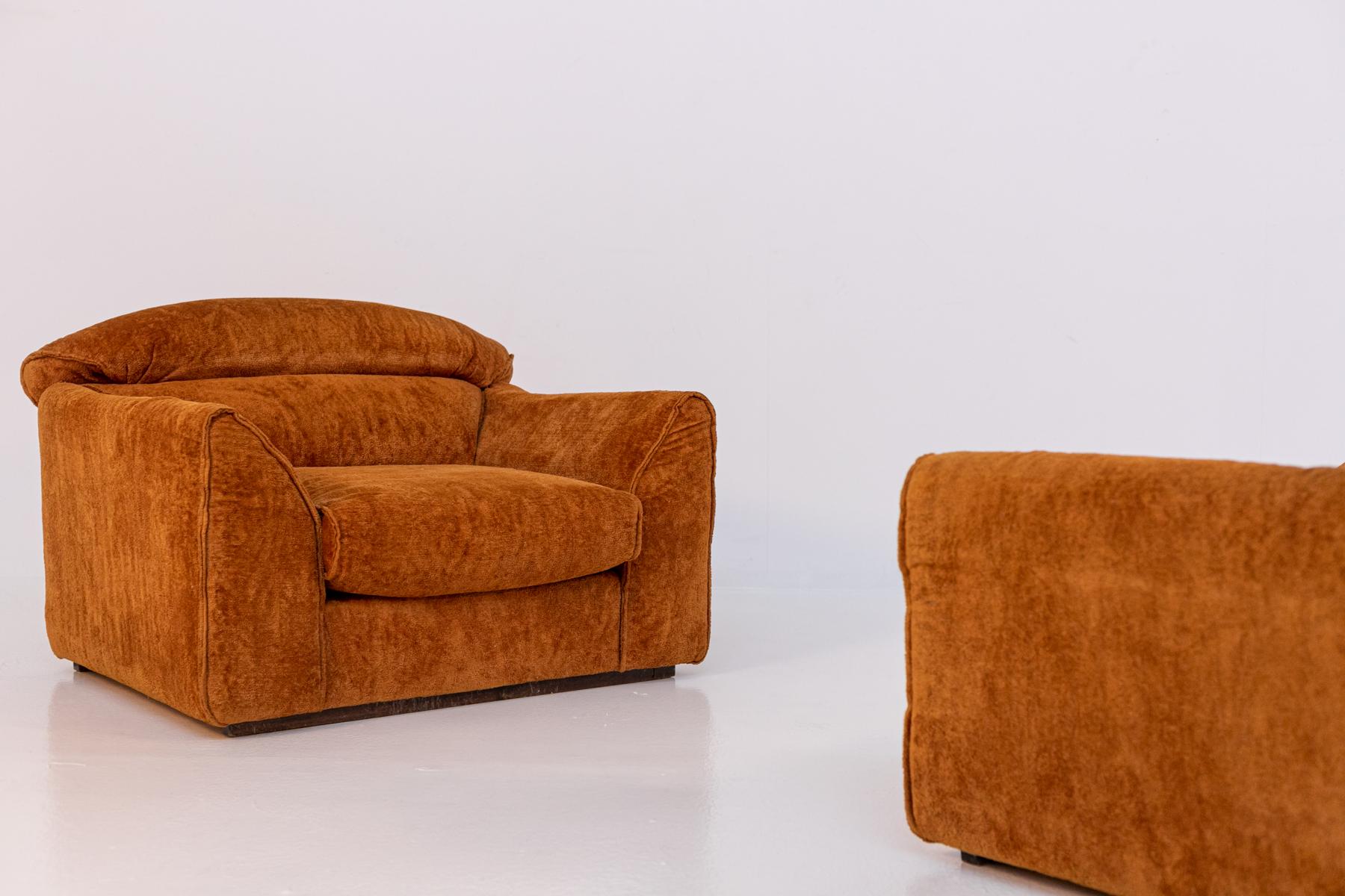 Gorgeous and rare pair of armchairs designed by D'Urbino, De Pas and Lomazzi in the 1970s. The armchairs are in original condition and are upholstered in dark orange velvet. Fine Italian workmanship, beautiful shape and absolute comfort for the