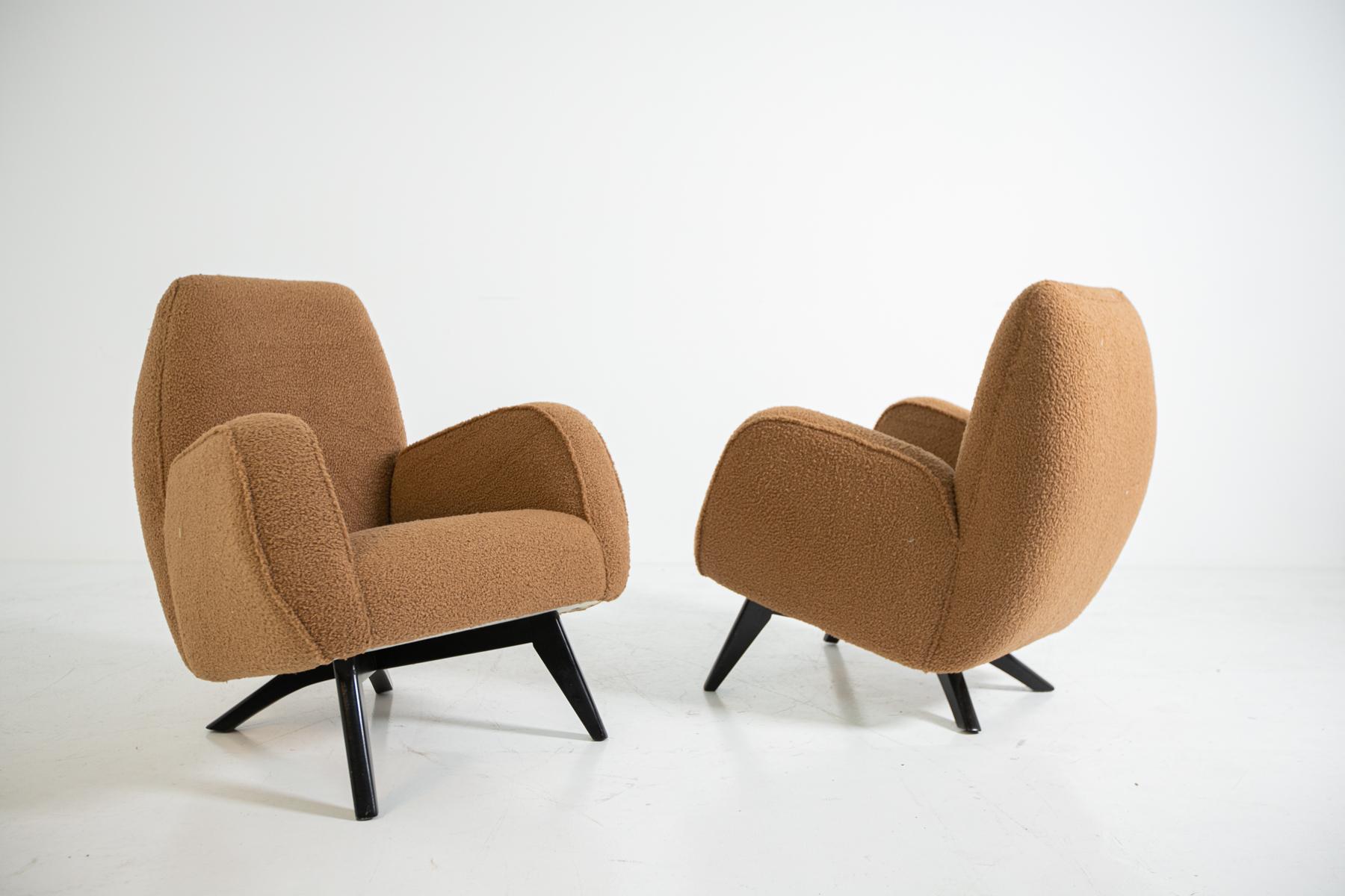 Magnificent pair of Melchiorre Bega armchairs from the 1950s. Melchiorre Bega armchairs have a very soft and comfortable line. Their rounded line completely envelops its guest. Giving strength to its enveloping line is its brown bouclè fabric