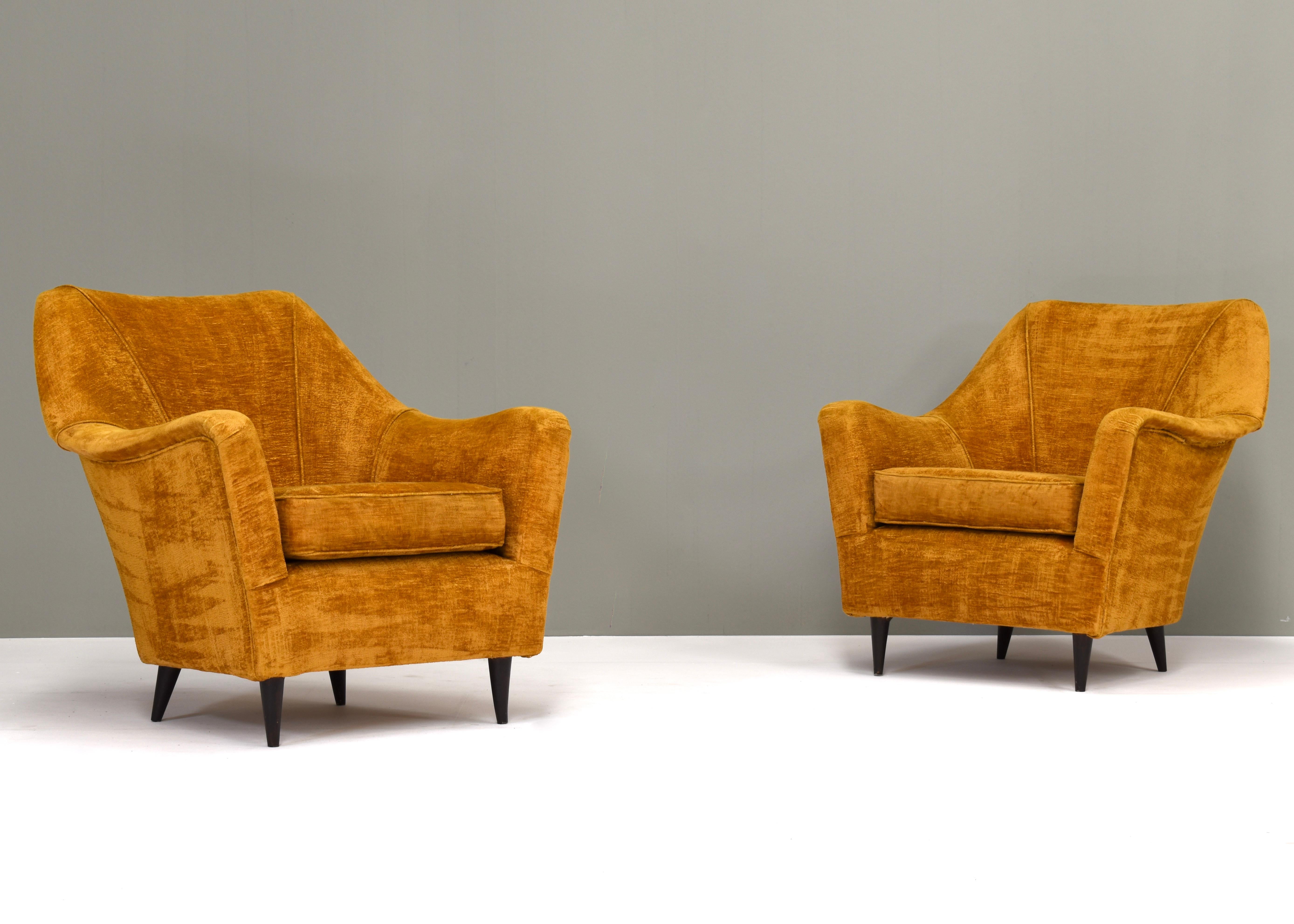 Pair of Italian 1950’s armchairs in original fabric. By or in the style of Ico Parisi (Ariberto Colombo).
The chairs have wear on the armrests and some edges. The fabric has been cleaned professionally. 

Designer: by or in the style of Ico