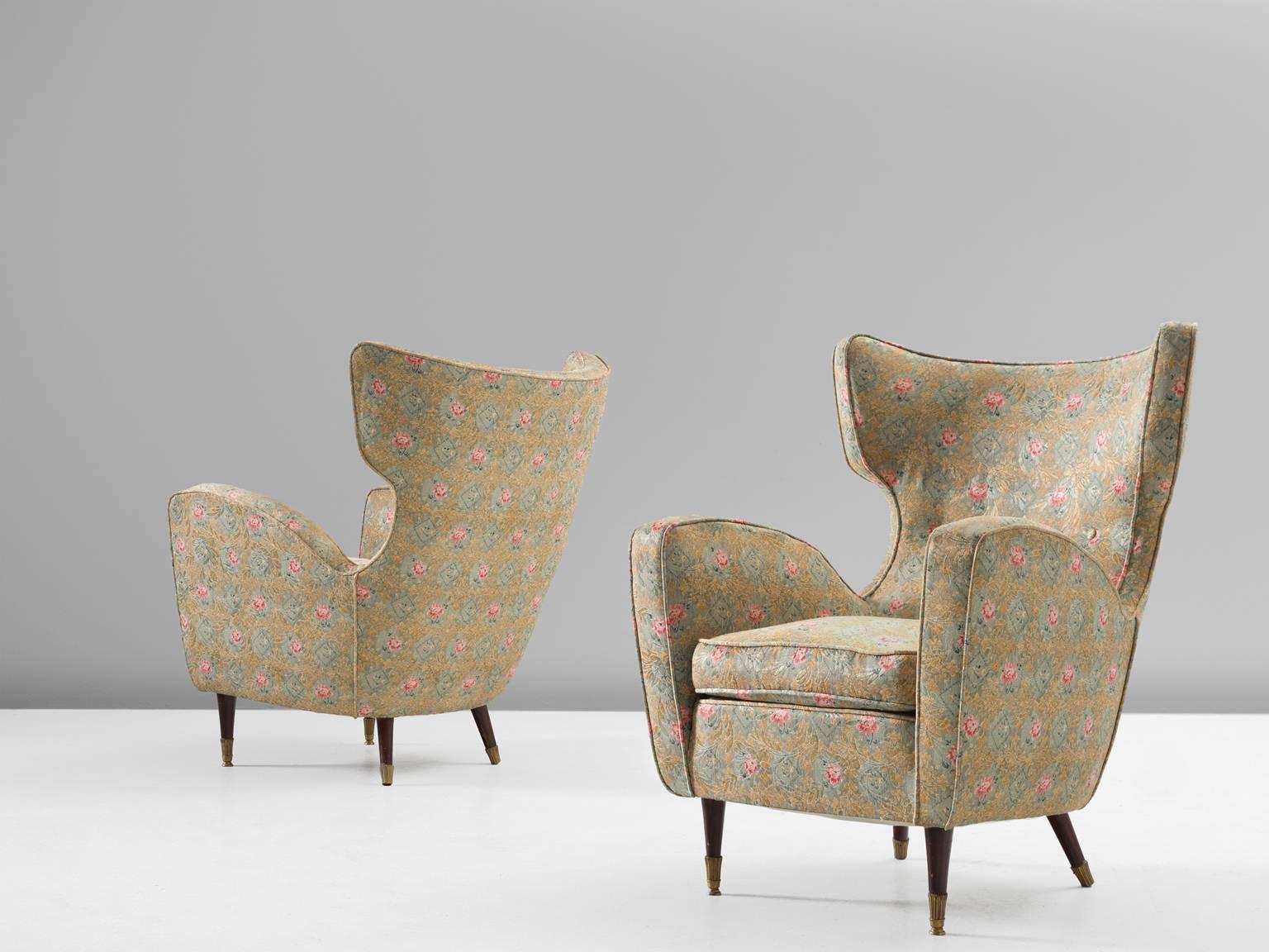 Two lounge chairs, fabric, wood and brass, Italy, 1950s.

This wonderful pair of elegant and small wingback chairs are upholstered in a perfect way. The edges and corners of these chairs are very refined and enhanced by the seam. The little,