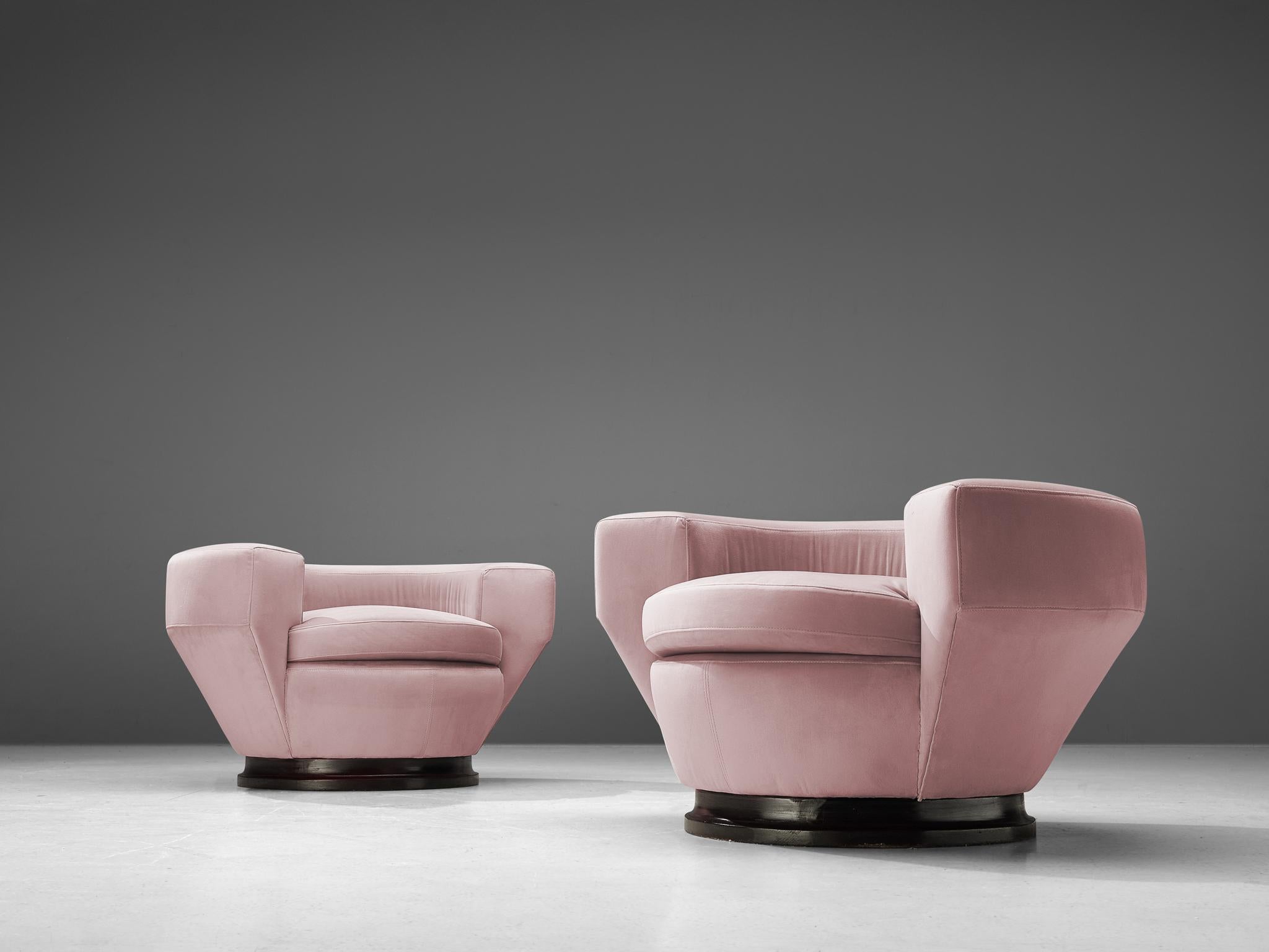 Pair of armchairs, pink ultra-suede upholstery, darkened wood, Italy, 1960s

Stunning pair of lounge chairs made in Italy in the 1960s. Remarkable about these armchairs is their round shape and the low backrest that merges seamlessly into the