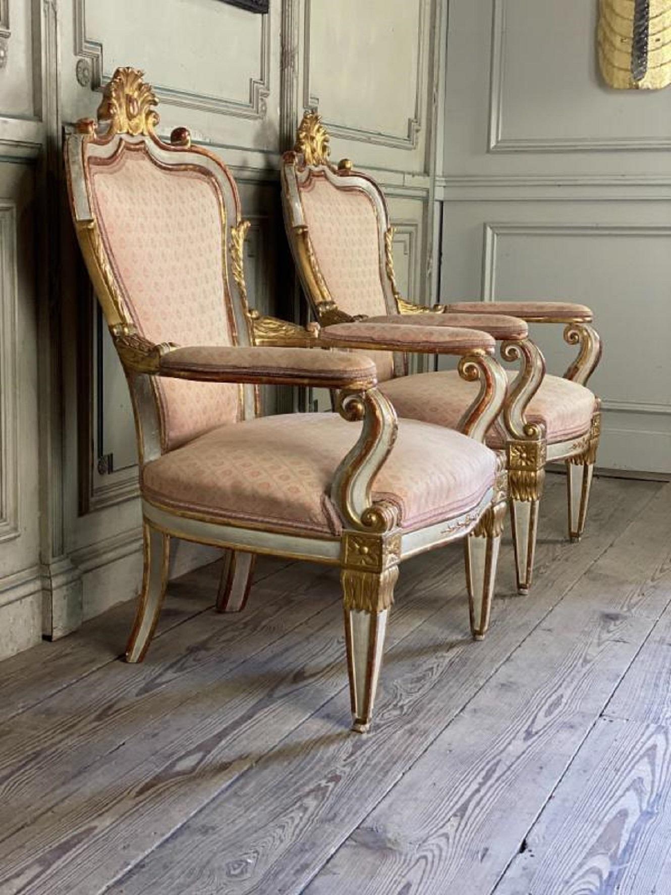 Pair of Italian armchairs in sculpted giltwood.