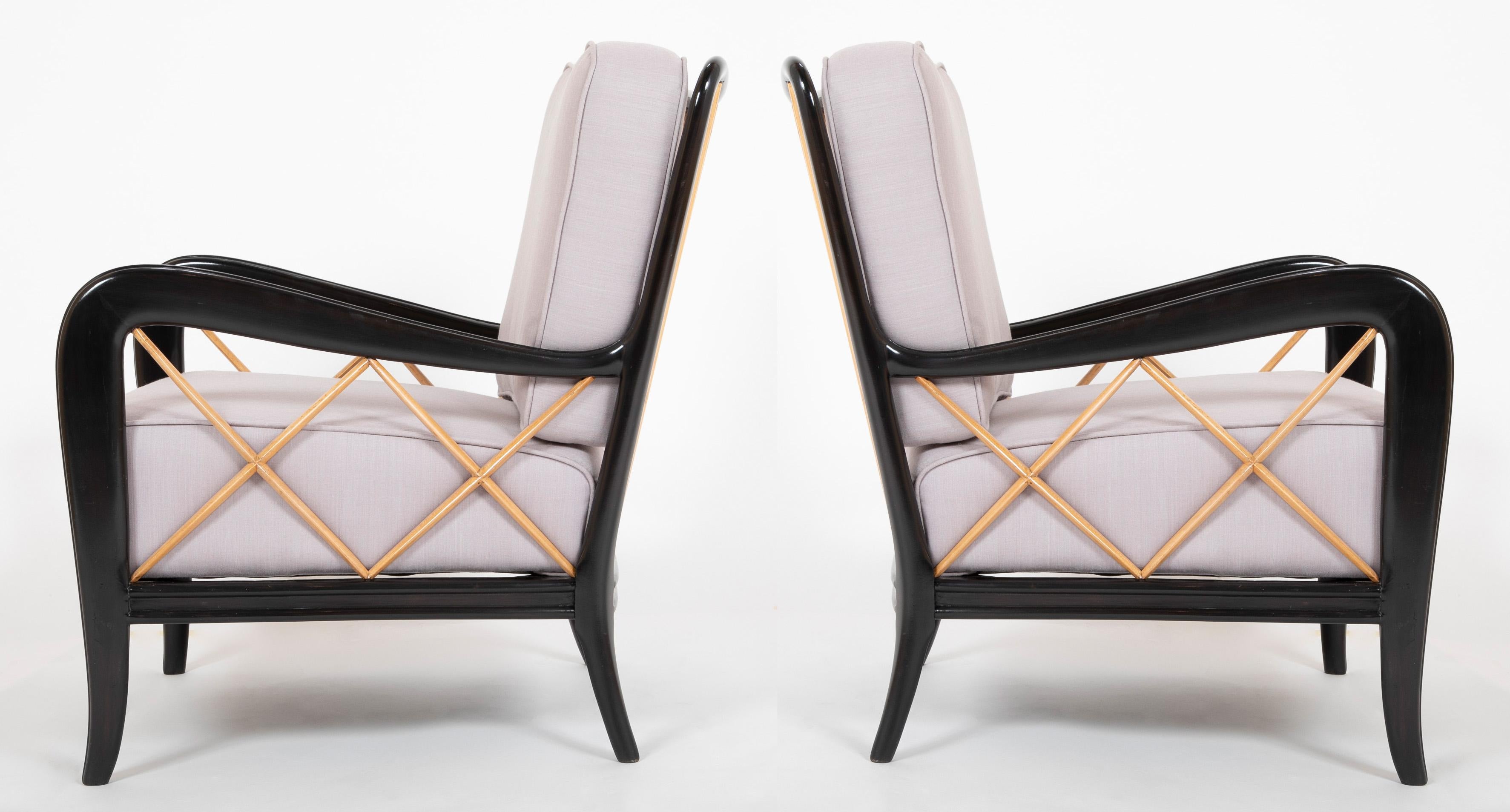 Pair of ebonized walnut frames with fruitwood crossed mullian filled arms.New cushions upholstered in Rogers and Goffigon in pale lavender upholstery.  

