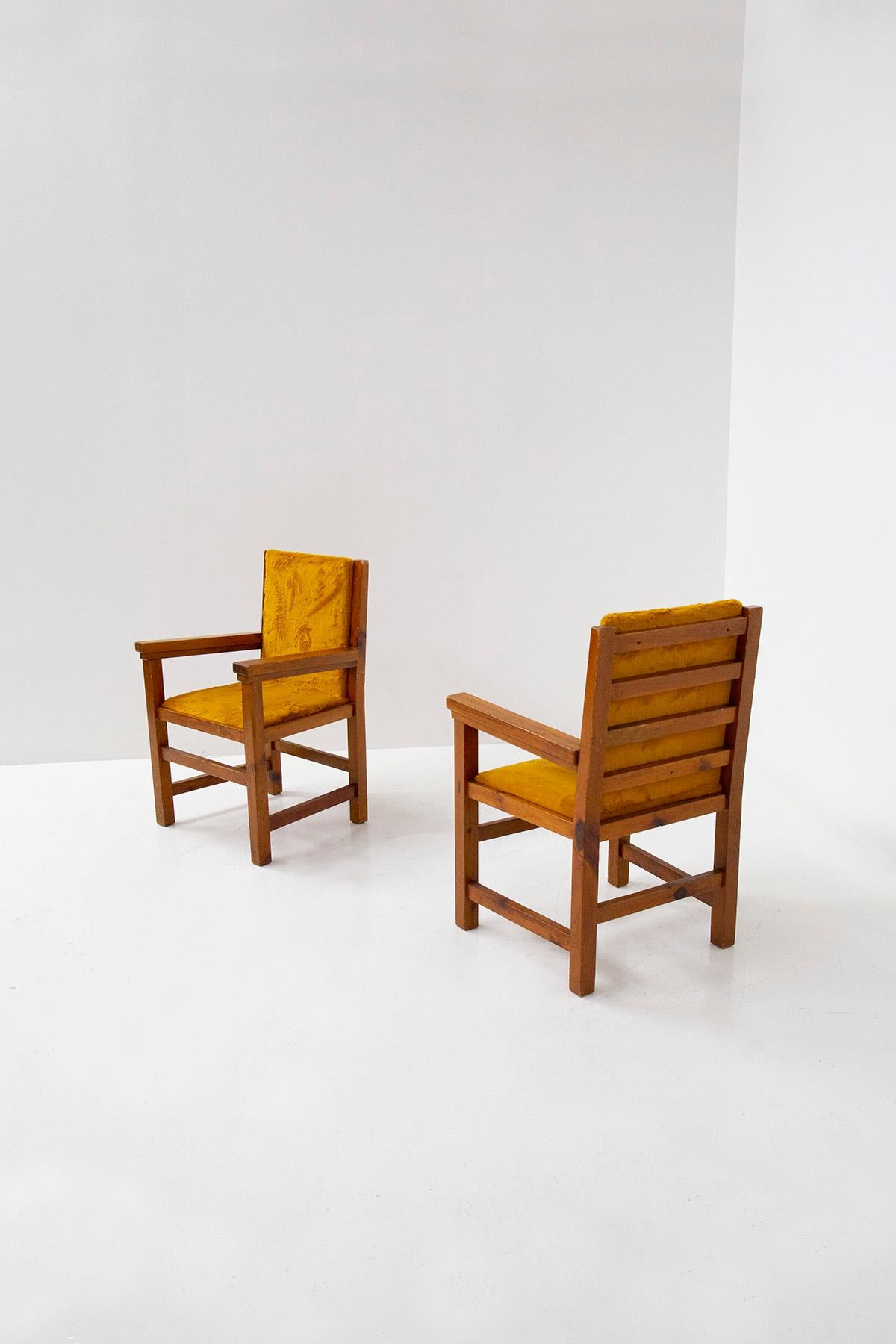 Beautiful pair of Italian armchairs from the 1960s. Collected from a large Italian mountain chalet. The pair of armchairs has a soft and elegant dark yellow fur . The frame is made of very solid walnut wood, with shapes typical of mountain