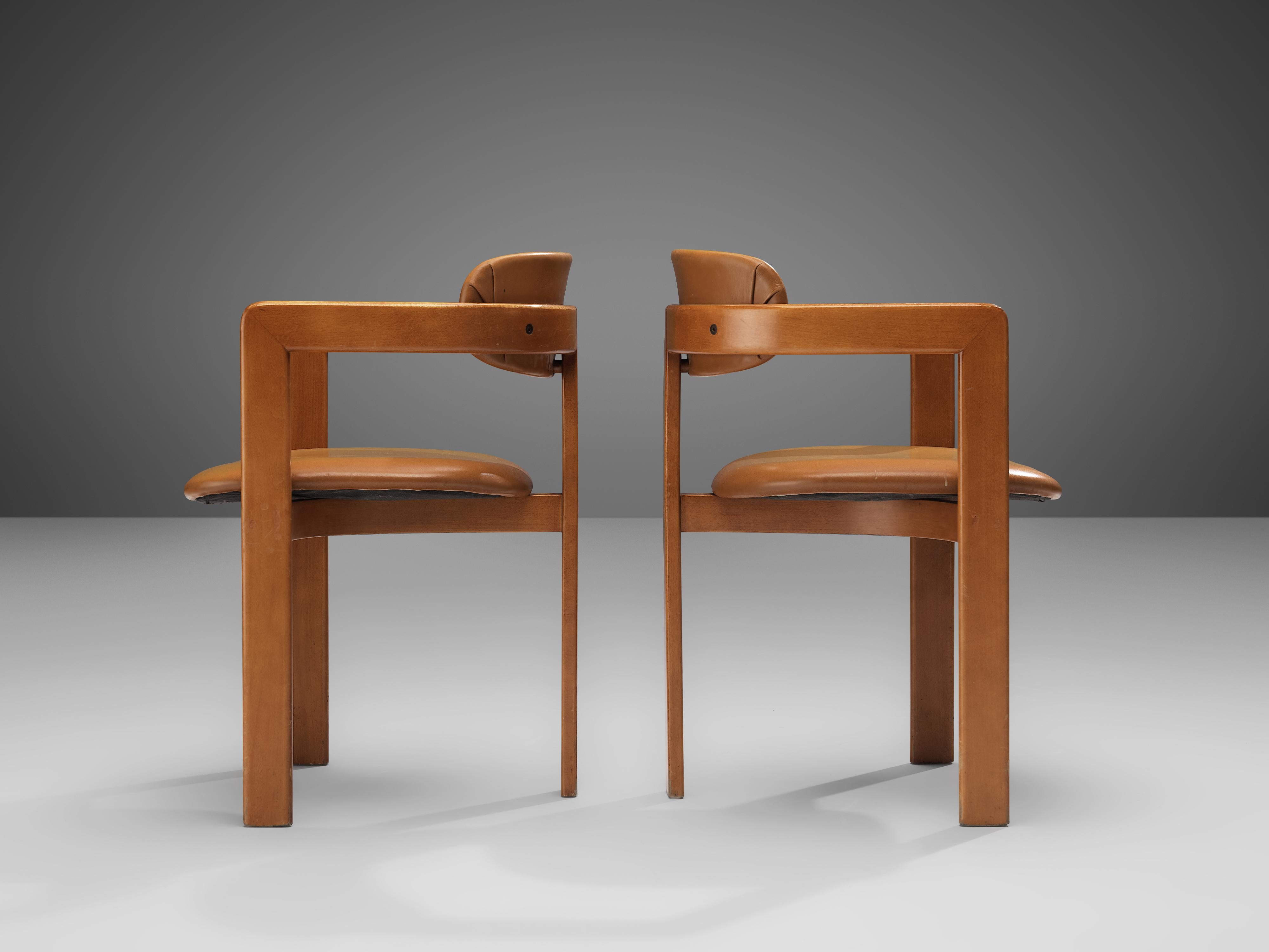 Pair of dining chairs, wood, leatherette, Italy, 1970s

This pair of Italian dining chairs has a strong resemblance to Augusto Savinis 'Pamplona' chair (1965) and Afra & Tobia Scrapas 'Pigreco' chair (1959/60) yet the designs are different in
