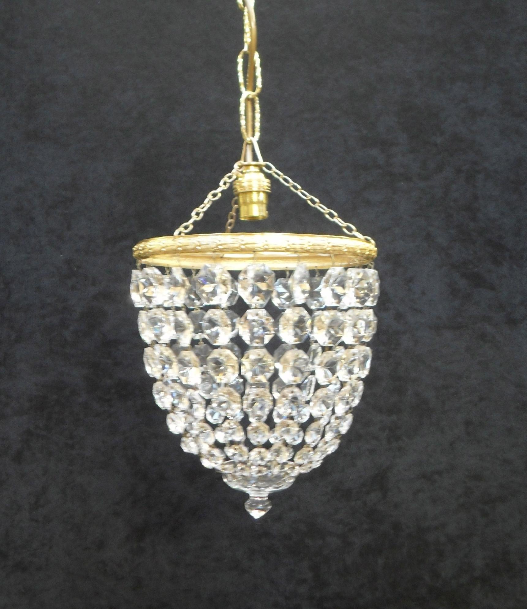 A very good quality pair of Italian Art Deco basket chandeliers with graduating diamond shaped cut crystal glass finished with a glass finial to the bottom with decorative brass frames on an adjustable 10 inch chain. The brass has been cleaned and