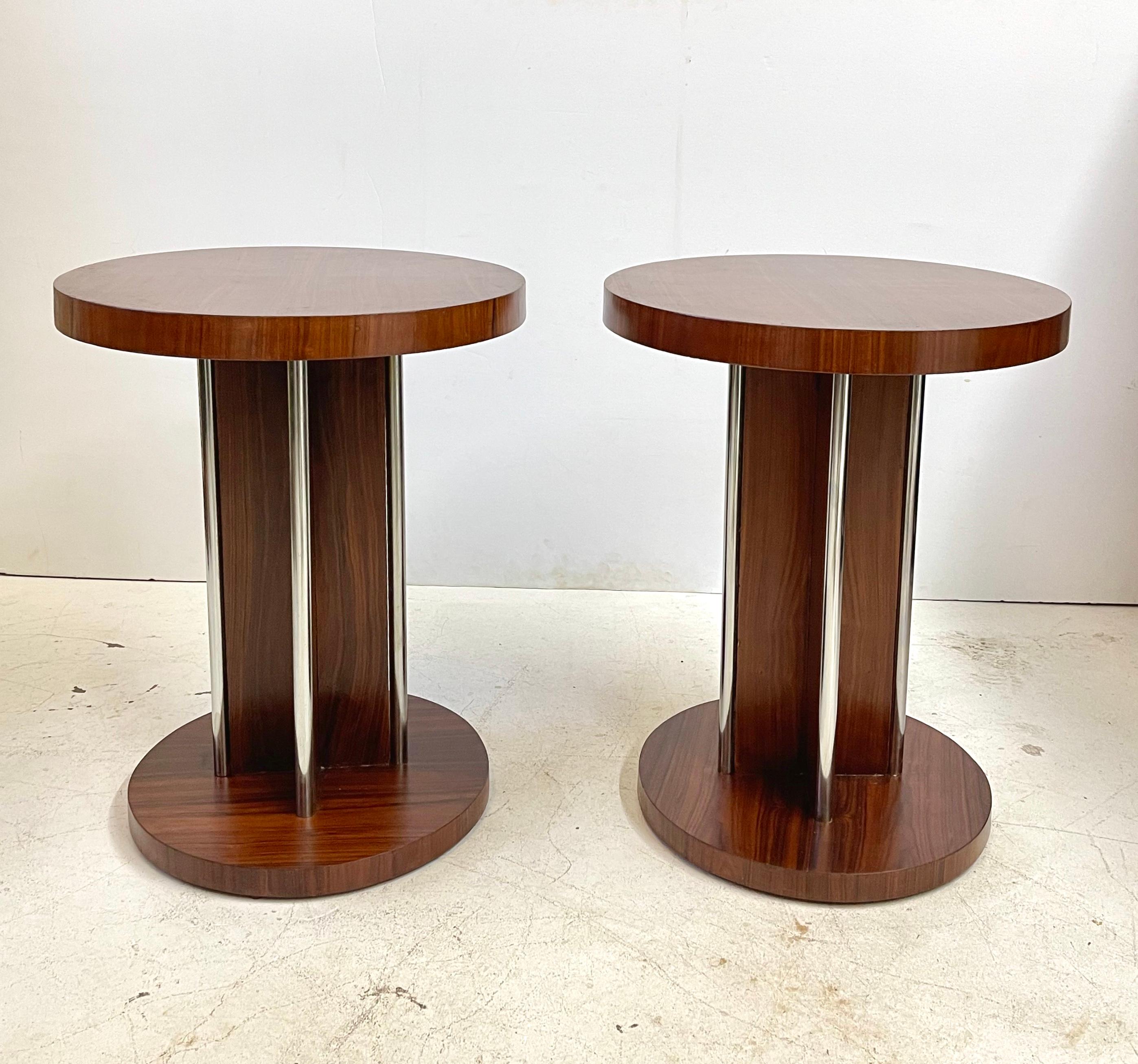 Pair of 20th century Italian cylindrical, pedestal form end tables in the Art Deco style. The tables are veneered in beautiful rosewood and accented by chrome fittings.