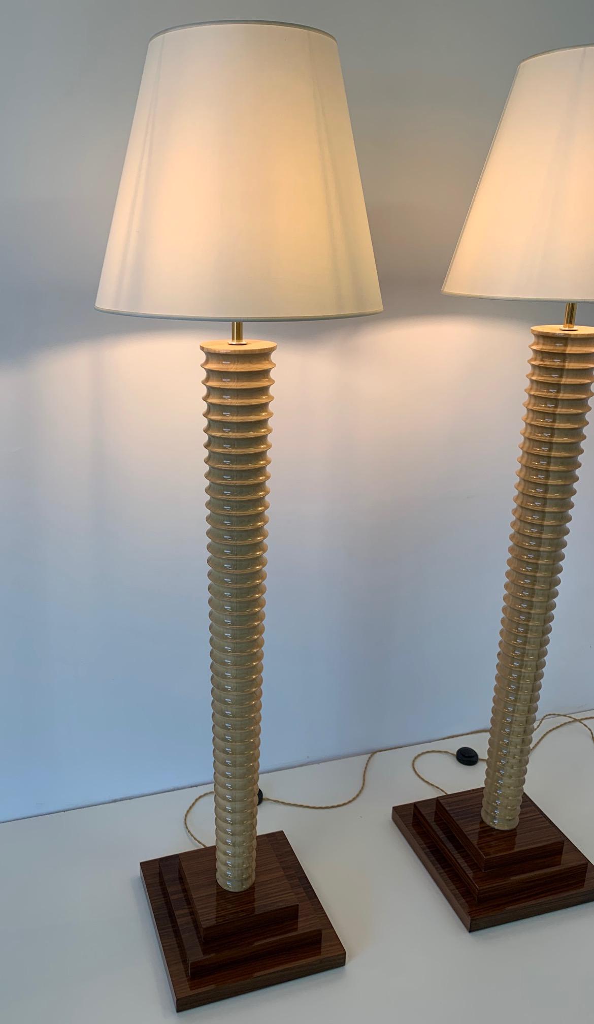 Pair of Art Deco style floor lamp made in Italy, in turned wood and precious ivory-colored lampshade.
Completely restored.