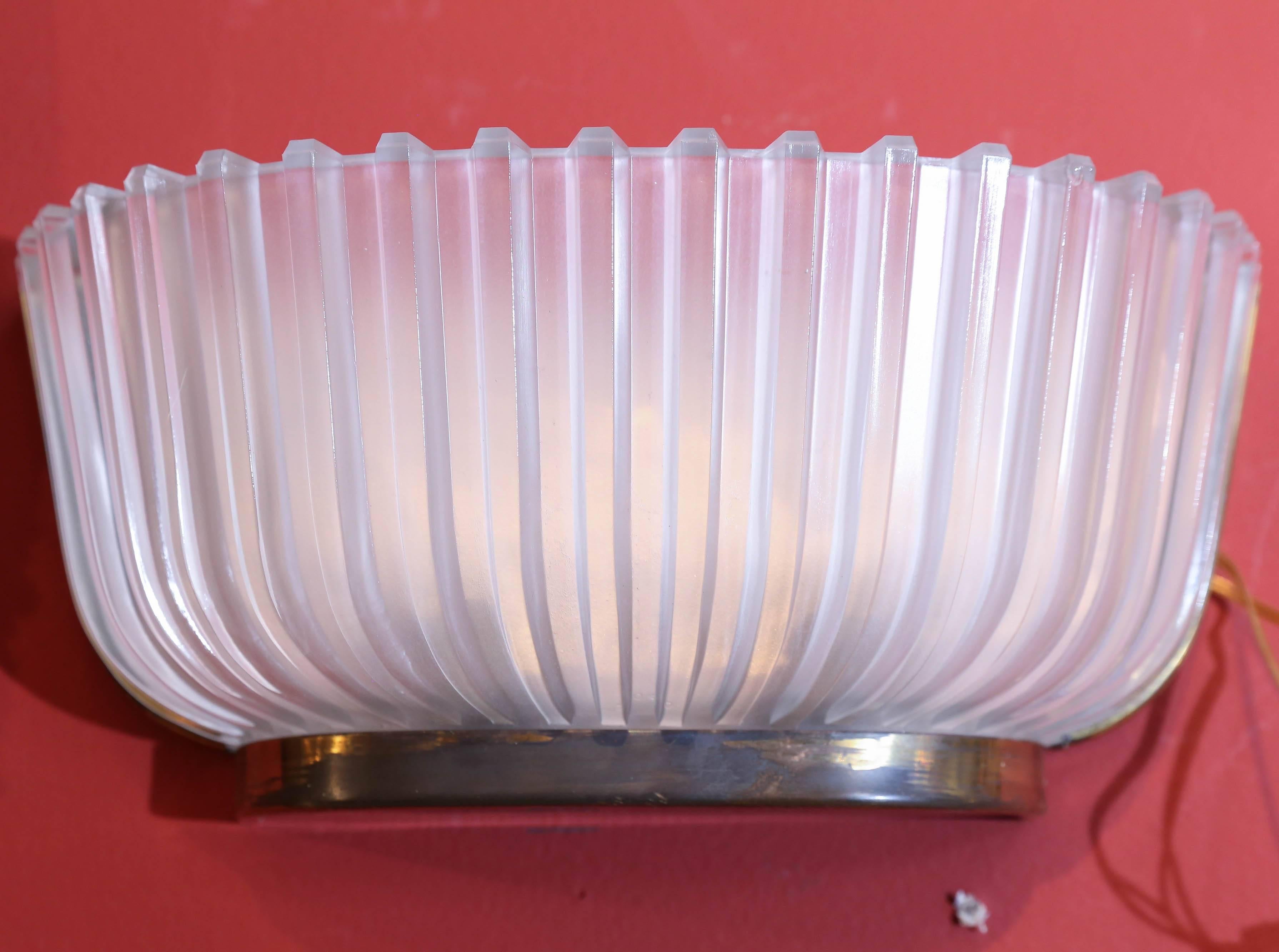 Art Deco glass wall sconces offered as a pair.
Contains two lights each sconce.