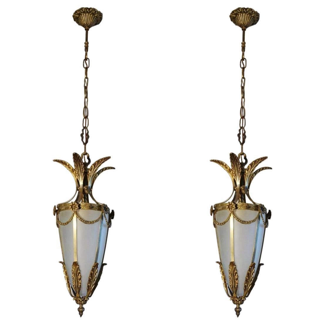 Pair of Art Deco lanterns, Italy, 1920s. Solid bronze and parcel brass with cone-shaped frosted glass shade.
Each lantern: One E27 brass and porcelain light socket for a large sized bulb up to 60W - 100W.
Dimensions:
Total height with chain 41