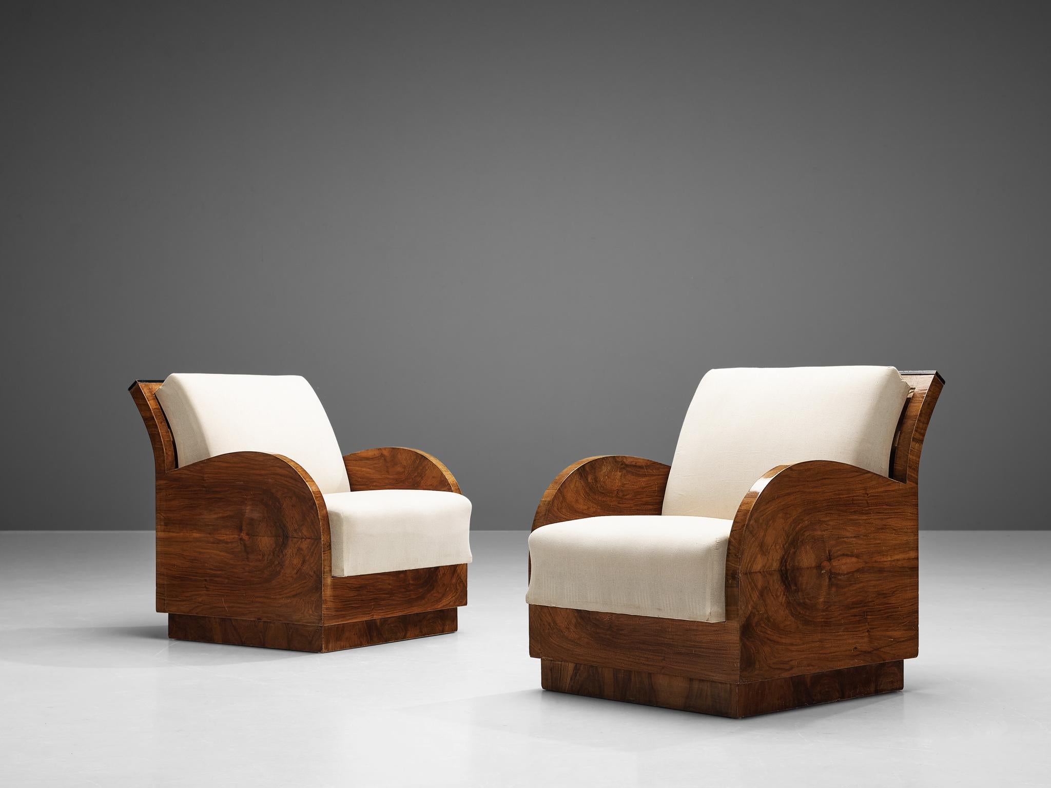 Art Deco lounge chairs, walnut, fabric upholstery , Italy, 1930s

Grand set of two Art Deco armchairs in and cream upholstery. Thanks to the beautiful bookmatched walnut frames an expressive contrast is created with the cream fabric. The