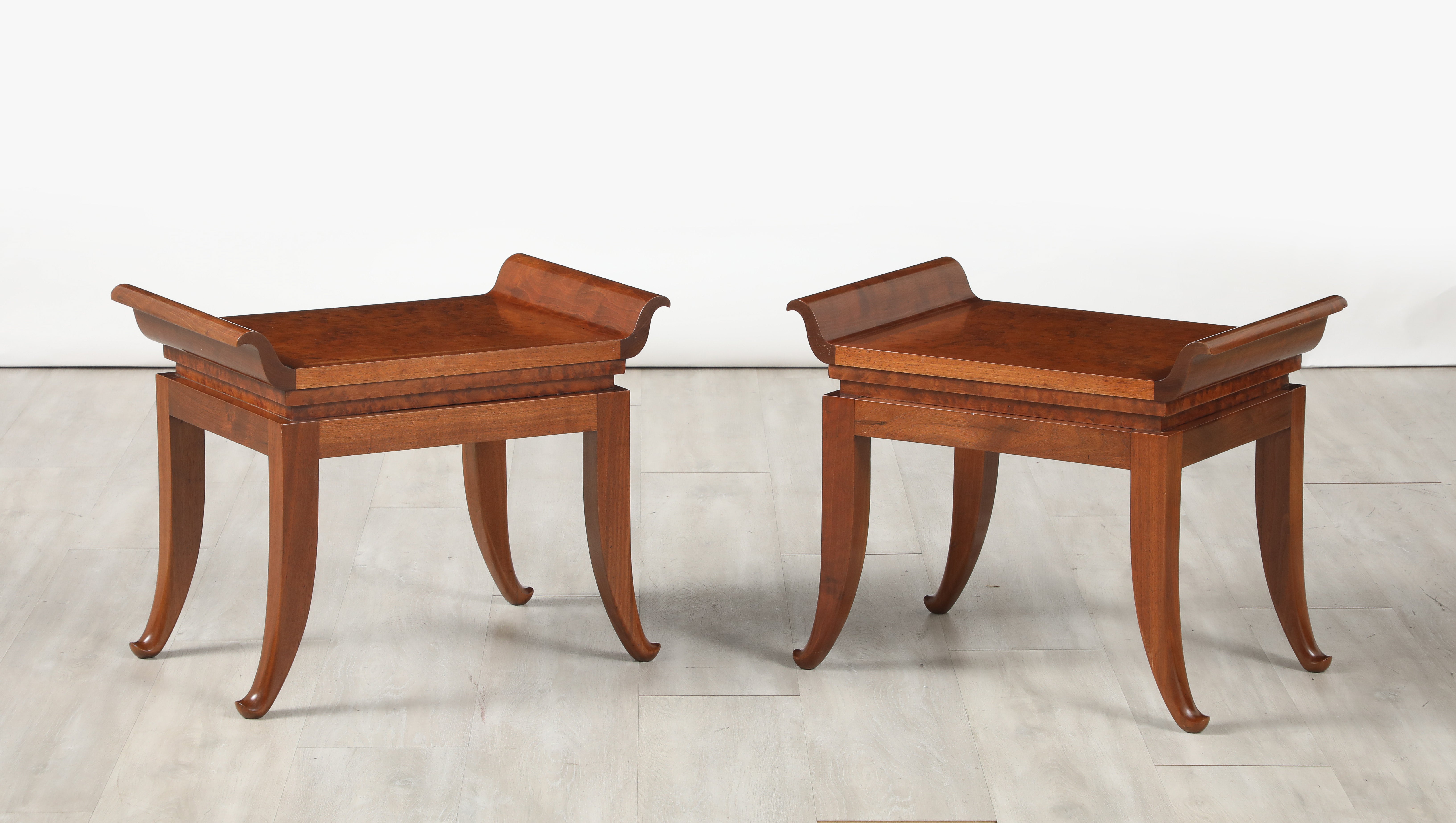 A Pair of Milanese mahogany stools with elegant sabre legs and seats with delicate scroll carving.  Of very high quality. 
Milan, Italy, circa 1930
Size: 18