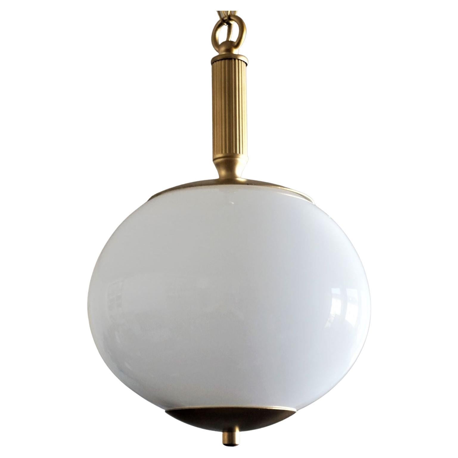Pair of hand blown oval opaline globe pendants, brass mounts, chain and canopy, Italy, 1950s.
With a single brass and porcelain Edison E-27 light socket for large sized bulb (each pendant).
Measures: Height 33 in / 84 cm, adjustable by extending