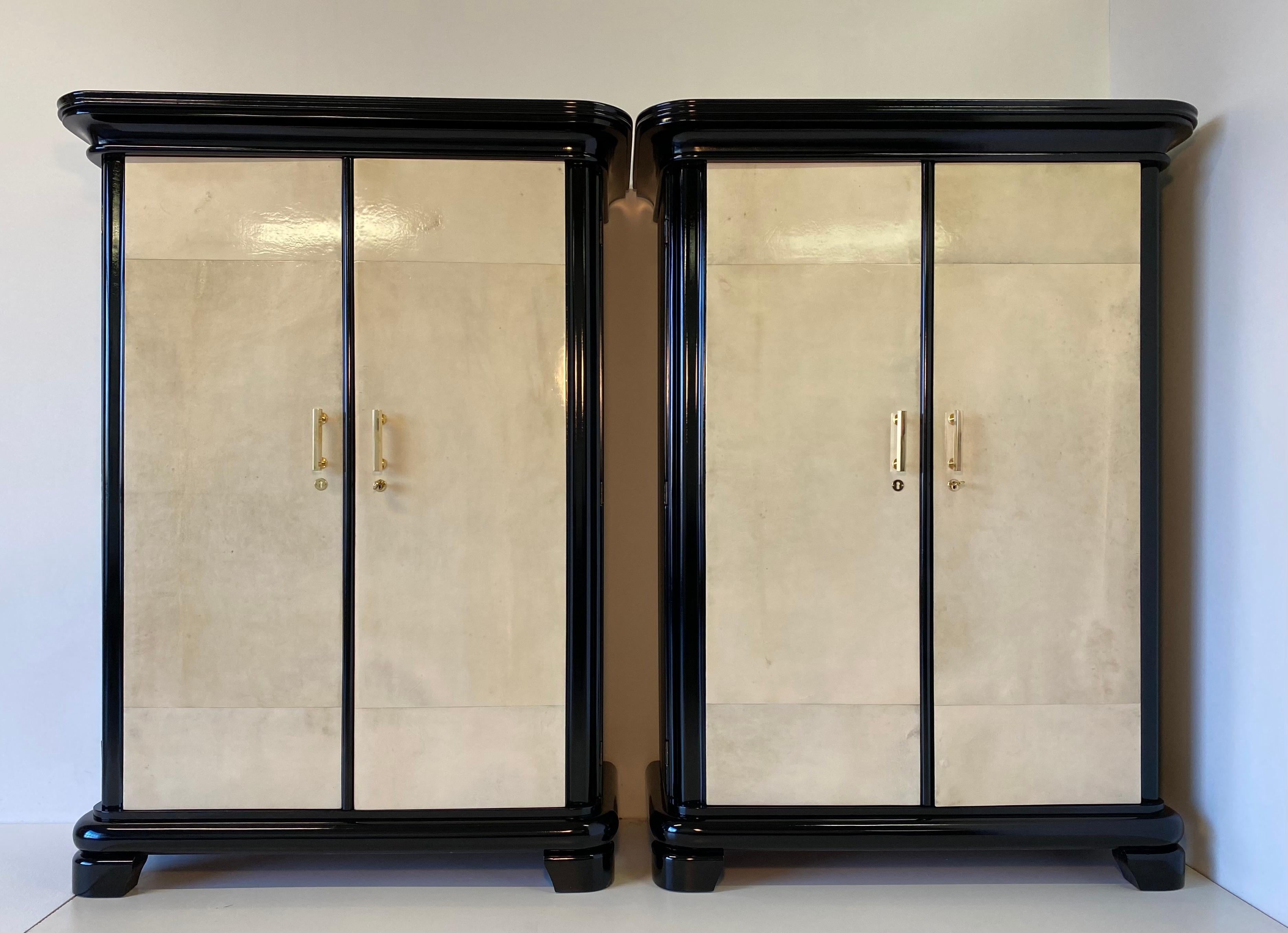 This pair of wardrobes - bookcases was produced in Italy in the 1930s made from solid black wood with the doors covered in fine parchment.
The handles and keys are made of brass, the shelves are finely finished.
Fully restored.