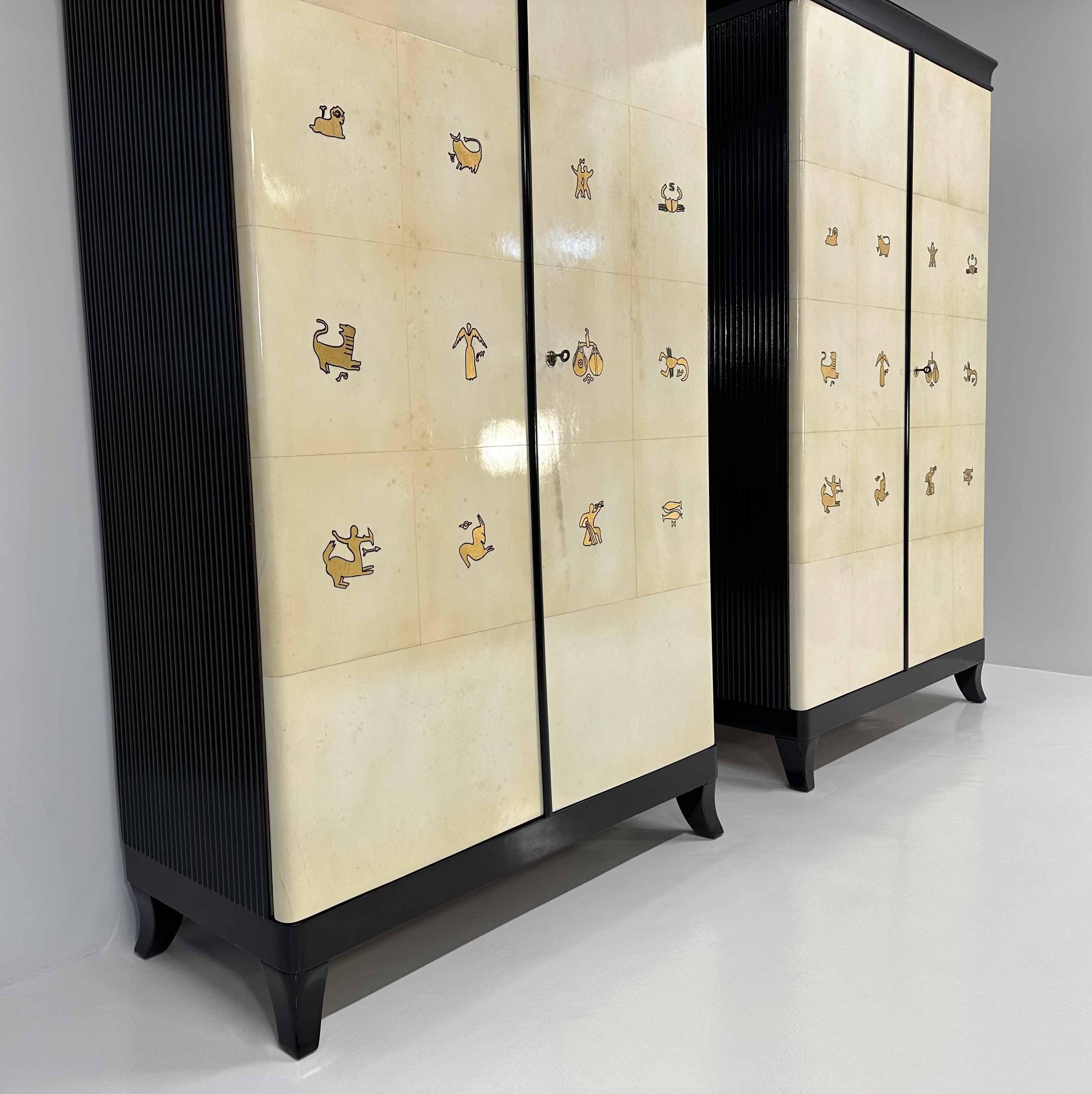 Pair of Italian Art Deco Parchment, Black and Gold Leaf Zodiac Armoires