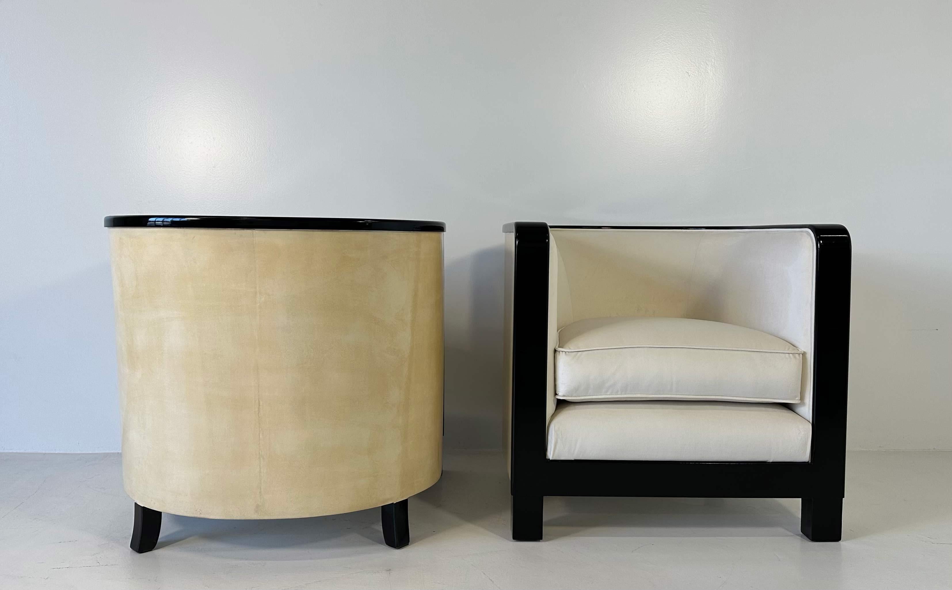 This stunning pair of Art Deco style armchairs was produced in Italy in the 1980s. 
The back is in parchment (goat skin), the frontal frame and the legs are black lacquered, while the seat is upholstered in a cream colored fine velvet. 
Completely