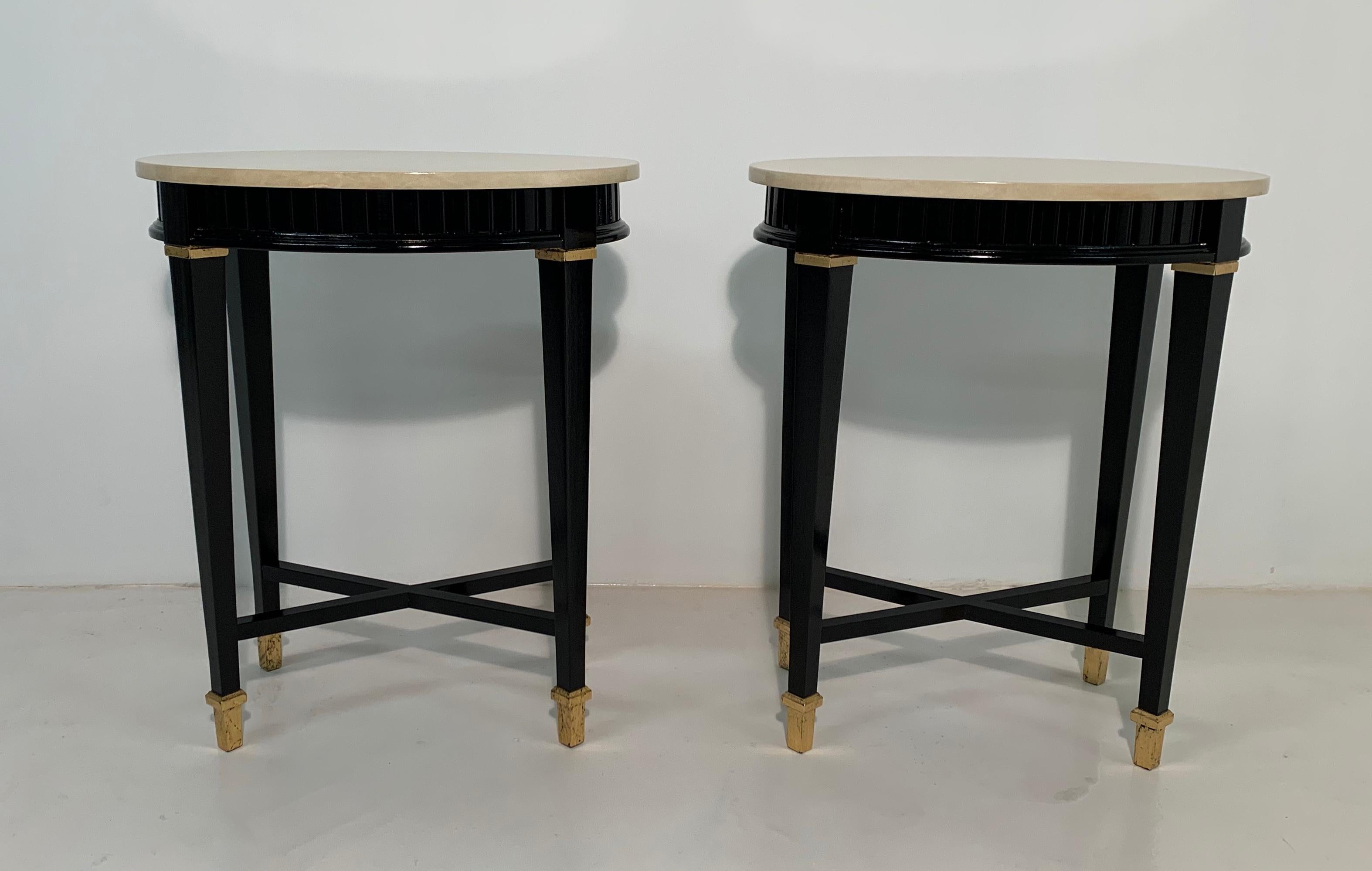 Pair of Art Deco style coffee tables or nightstands made in Italy, parchment top, black legs and profiles and gold leaf details.
Completely restored.