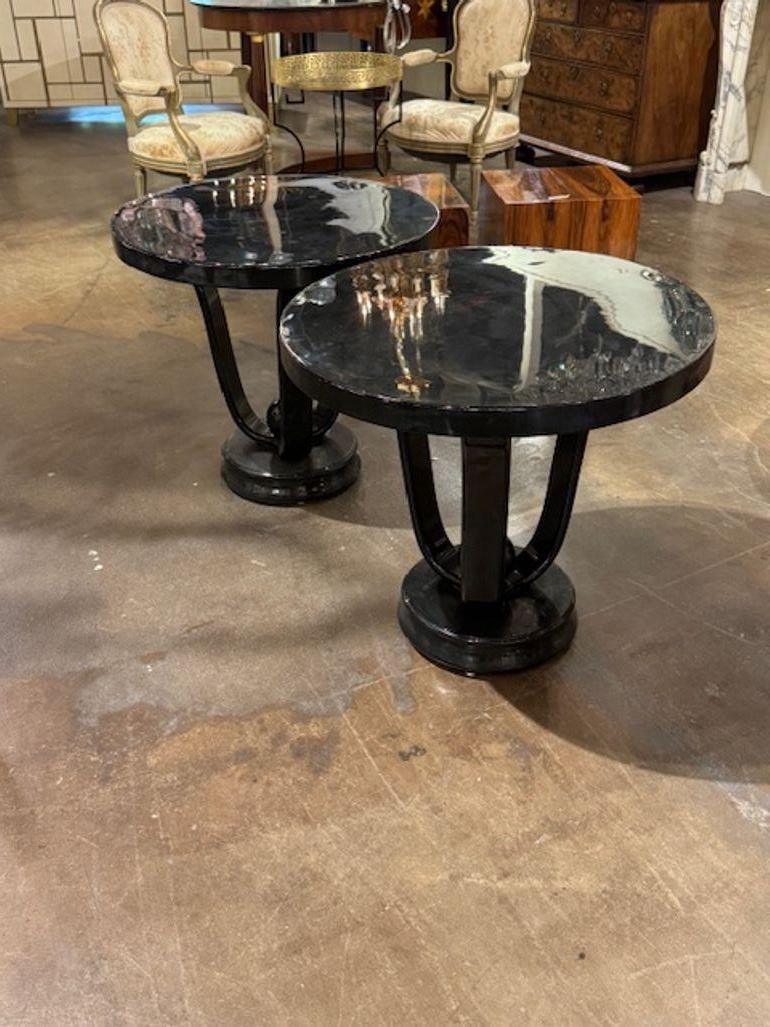 Nice pair of Italian Art Deco style piano black lacquered side tables. These tables are perfect for layering into a modern or vintage-inspired space.  27.5w x 28h