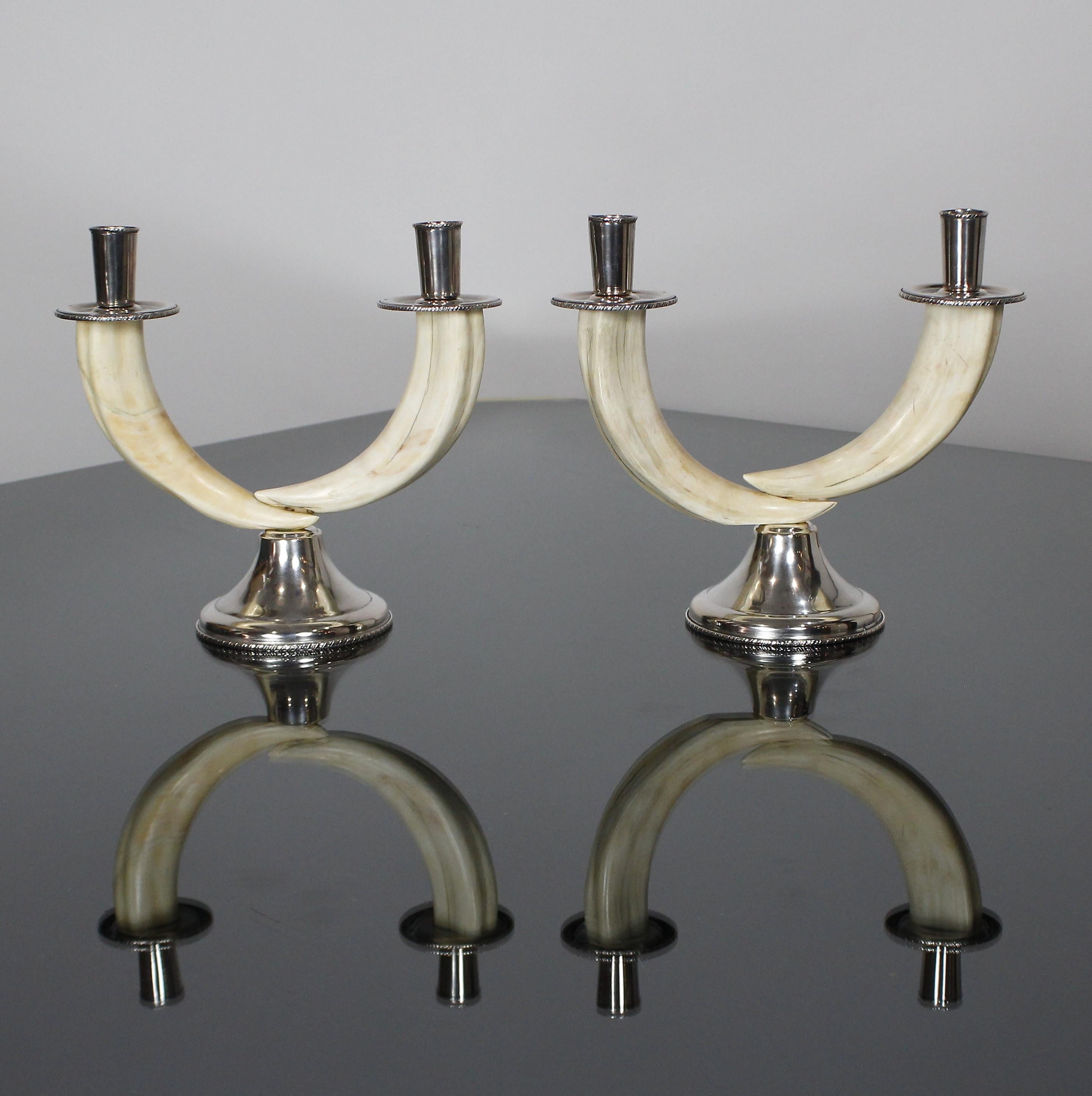 Pair of Italian colonial period (1925-1940) teeth warthog and silver mounted candlesticks with two arms.

800/000 Silver as shown in pictures.

Measurement units :

Inches 
Diameter 9.4 inch height 8.6 inch

Centimetres 
Diameter 24 cm Height 22