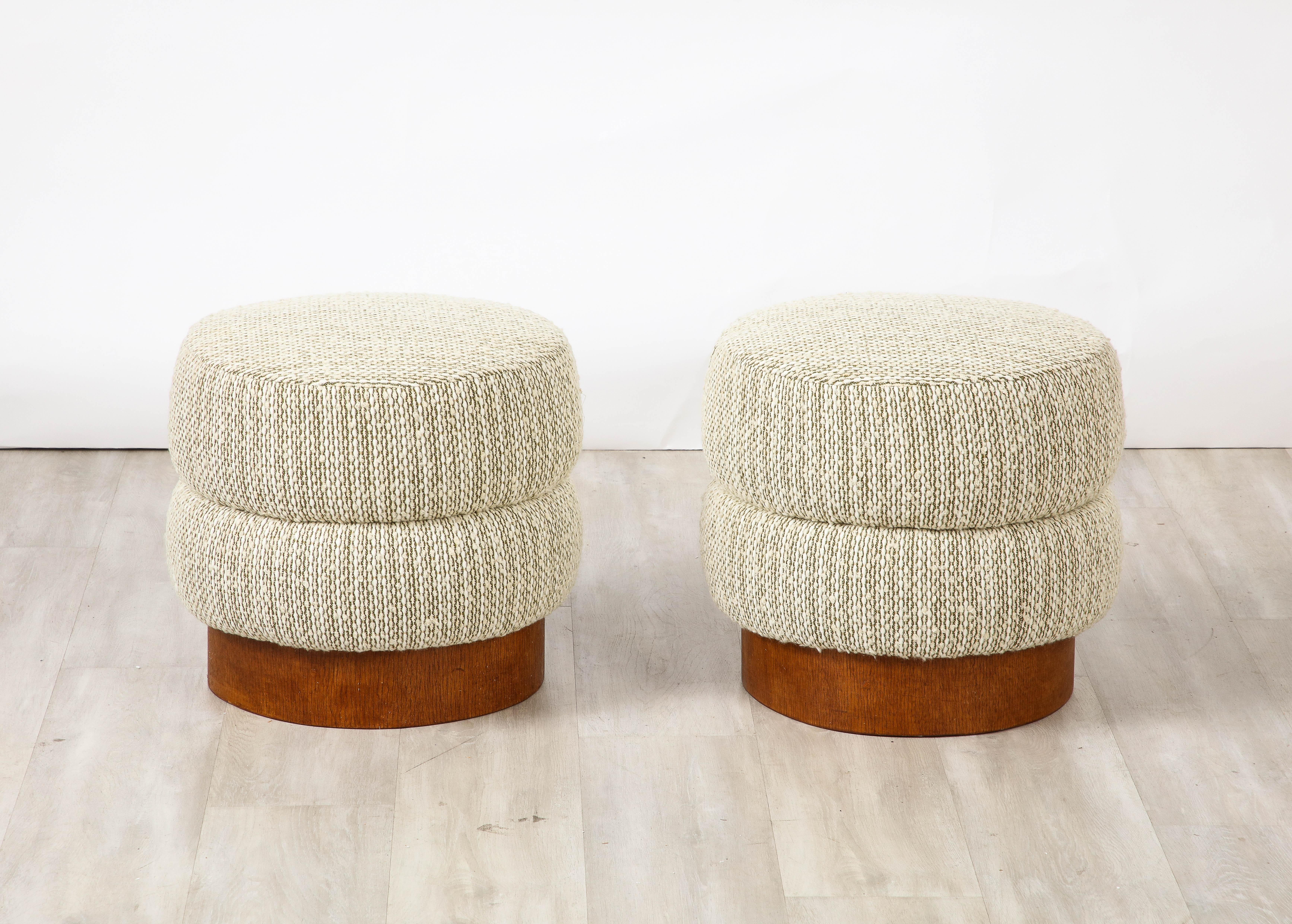 A pair of Italian Art Deco circular stools with walnut surround bases and upholstered channel seats.  Newly upholstered.
Italy, circa 1940 
Size: 15 3/4
