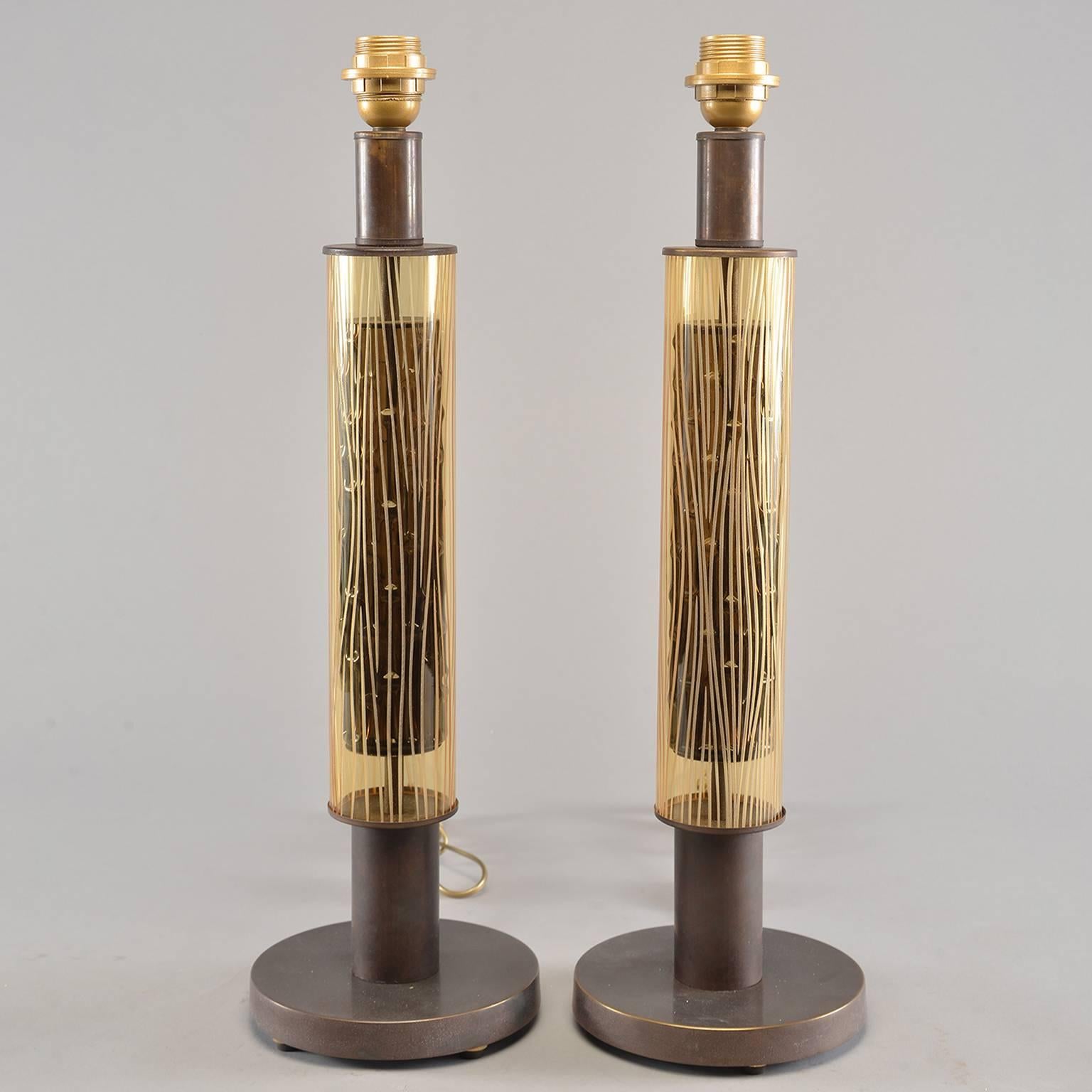 Pair of Italian table lamps have bronze colored metal base with etched amber glass cylinder over internal dark brown glass cylinder which gives glass a nice dimensionality. Lamps have been rewired for US electrical standards. Sold and priced as a