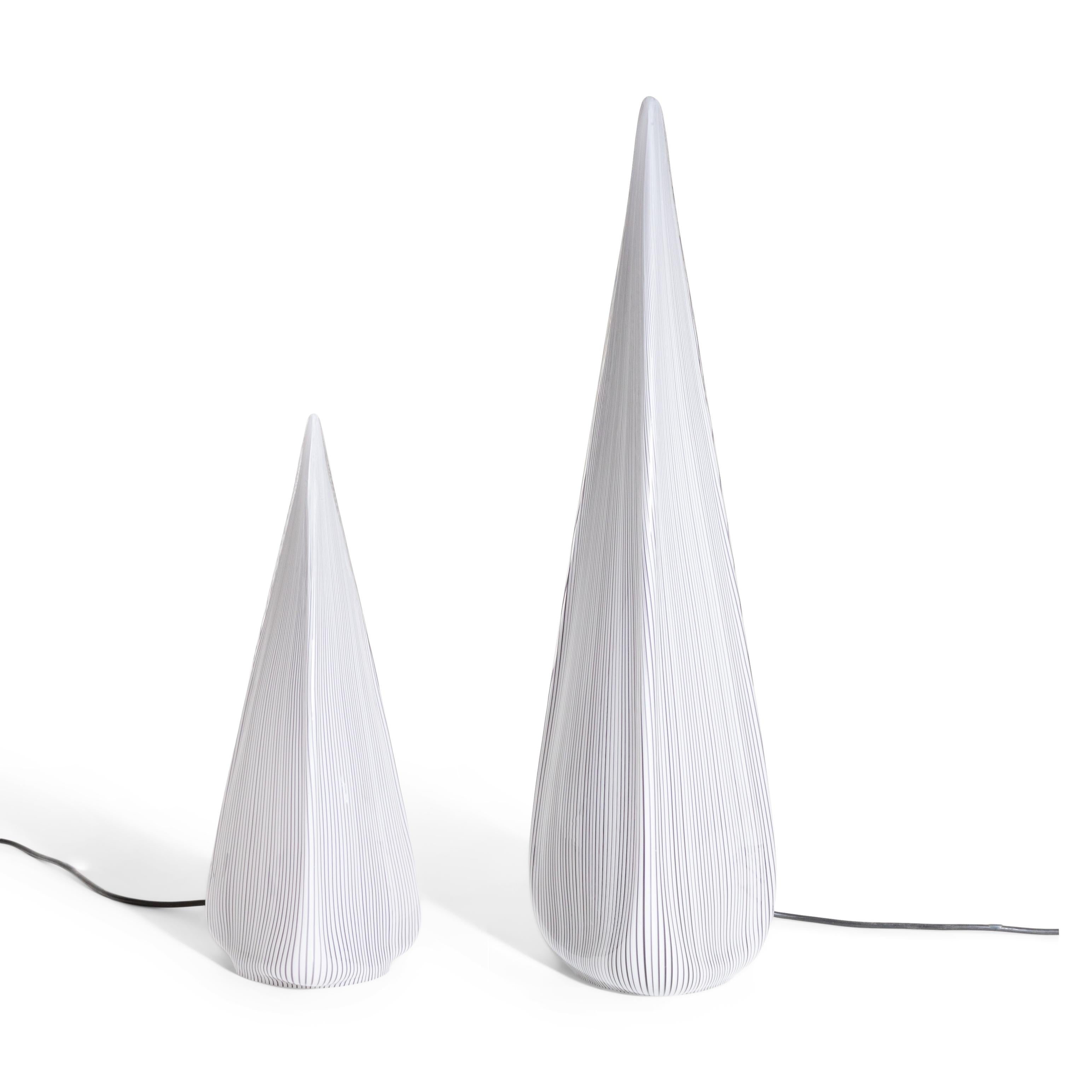 A pair of tear drop shaped Italian Art glass table lamps.
One Edison base light socket inside each glass casing, 
with gray and white vertical stripe pattern.

Dimensions Tall lamp H 28 ½, W 8¼, D 7, short lamp H 18¼, W 7¼, D 6 inches.

