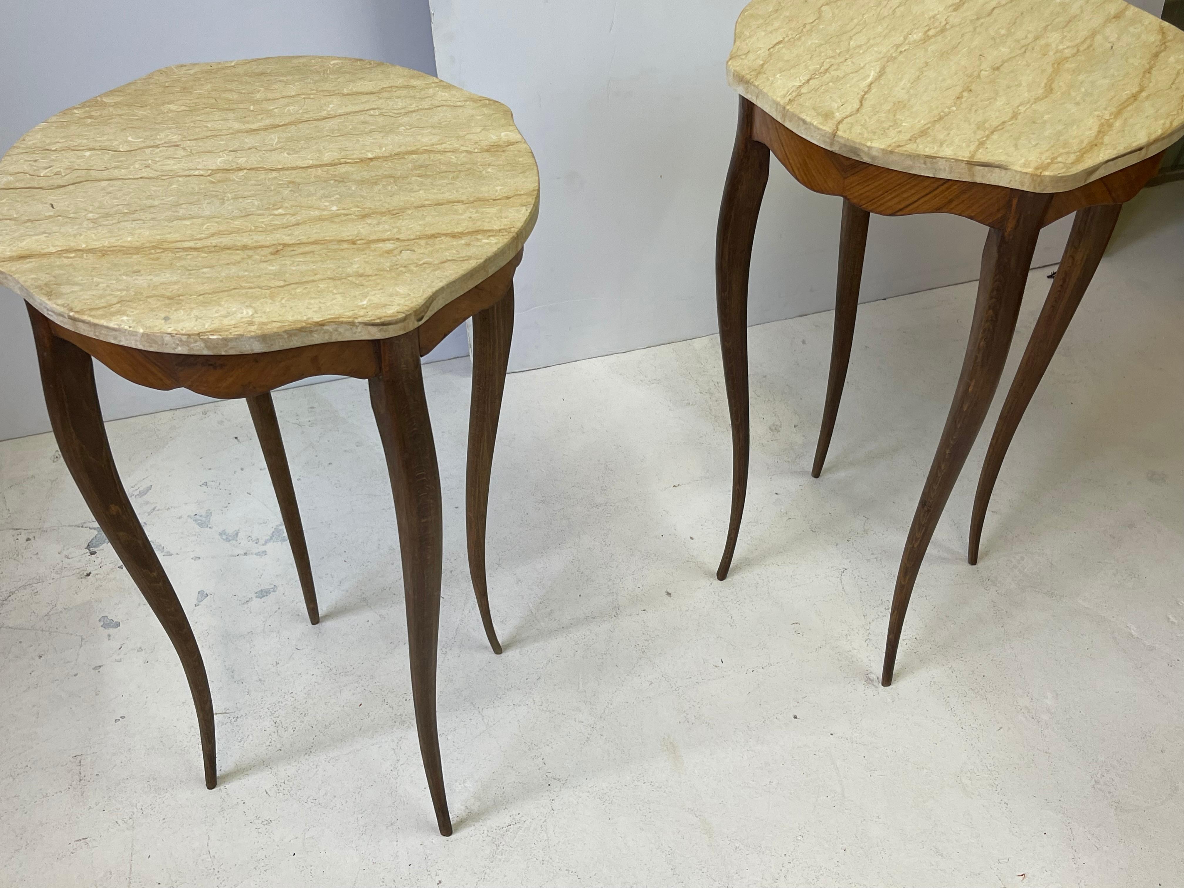 Unique pair of early 20th Century tables elegantly crafted with fine tapering legs, scalloped aprons and shaped marble tops. The tables were made in Italy of Kingswood and in the style of Art Nouveau, Circa 1910. 

The tables measure 30.25