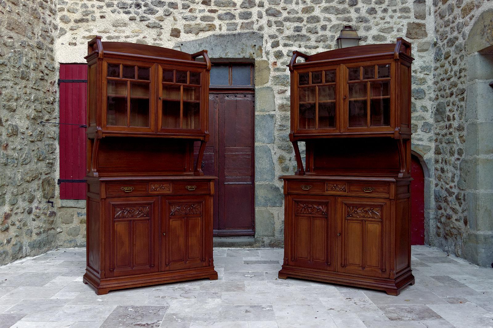 Beautiful pair of twin buffets / dressers / sideboards in walnut, carved with olive branches.

Each buffet is divided into two parts:
- the upper part with double glazed door (bevelled glass), has 1 shelf and 1 niche;
- the lower part has 2 drawers,