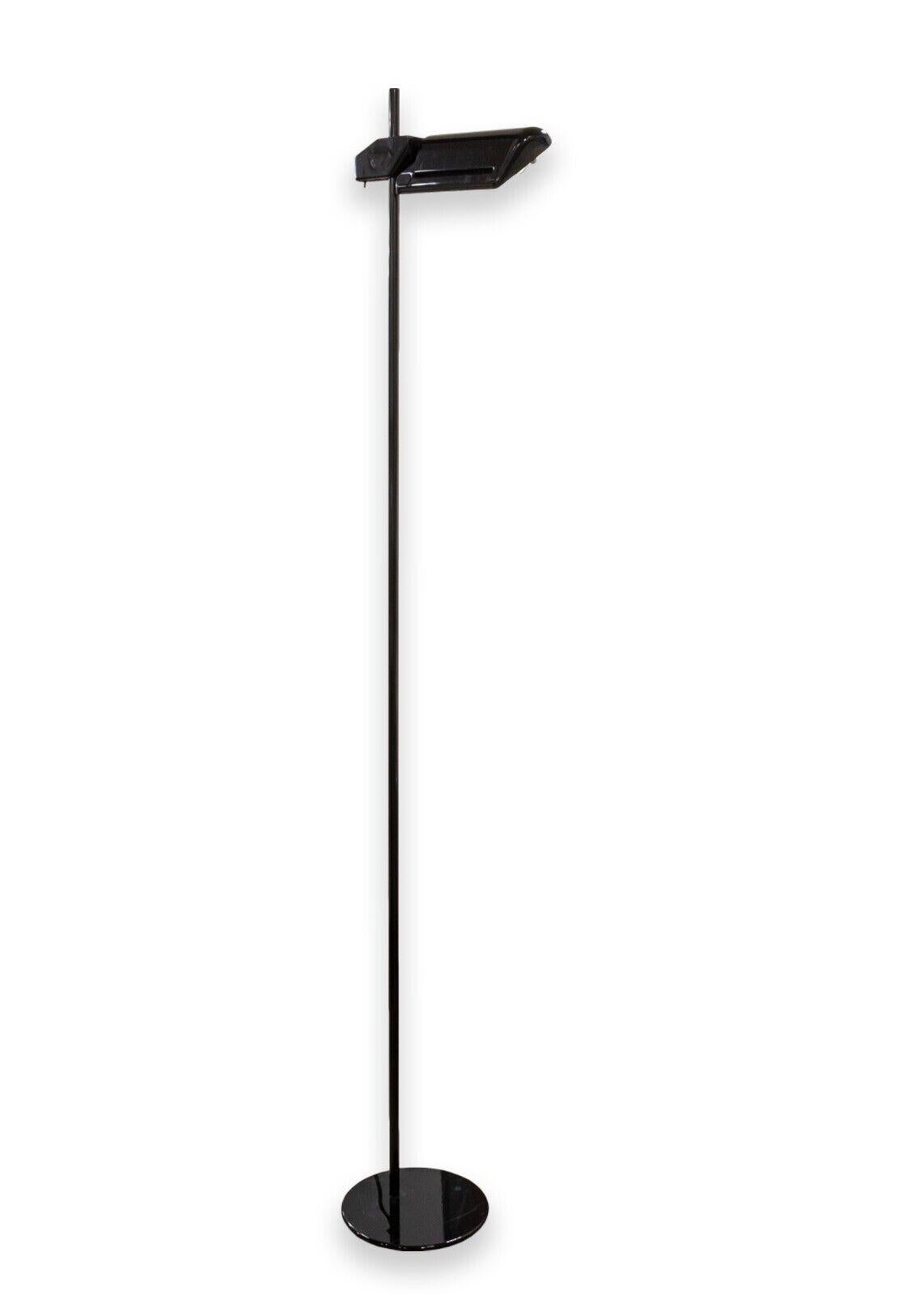 A pair of Arteluce BIS A700 floor lamps. An modern Italian set of floor lamps. These tall floor lamps feature a glossy black finish, a weighted circular base, and an adjustable head attached to the tall center pole. The switch for both of these