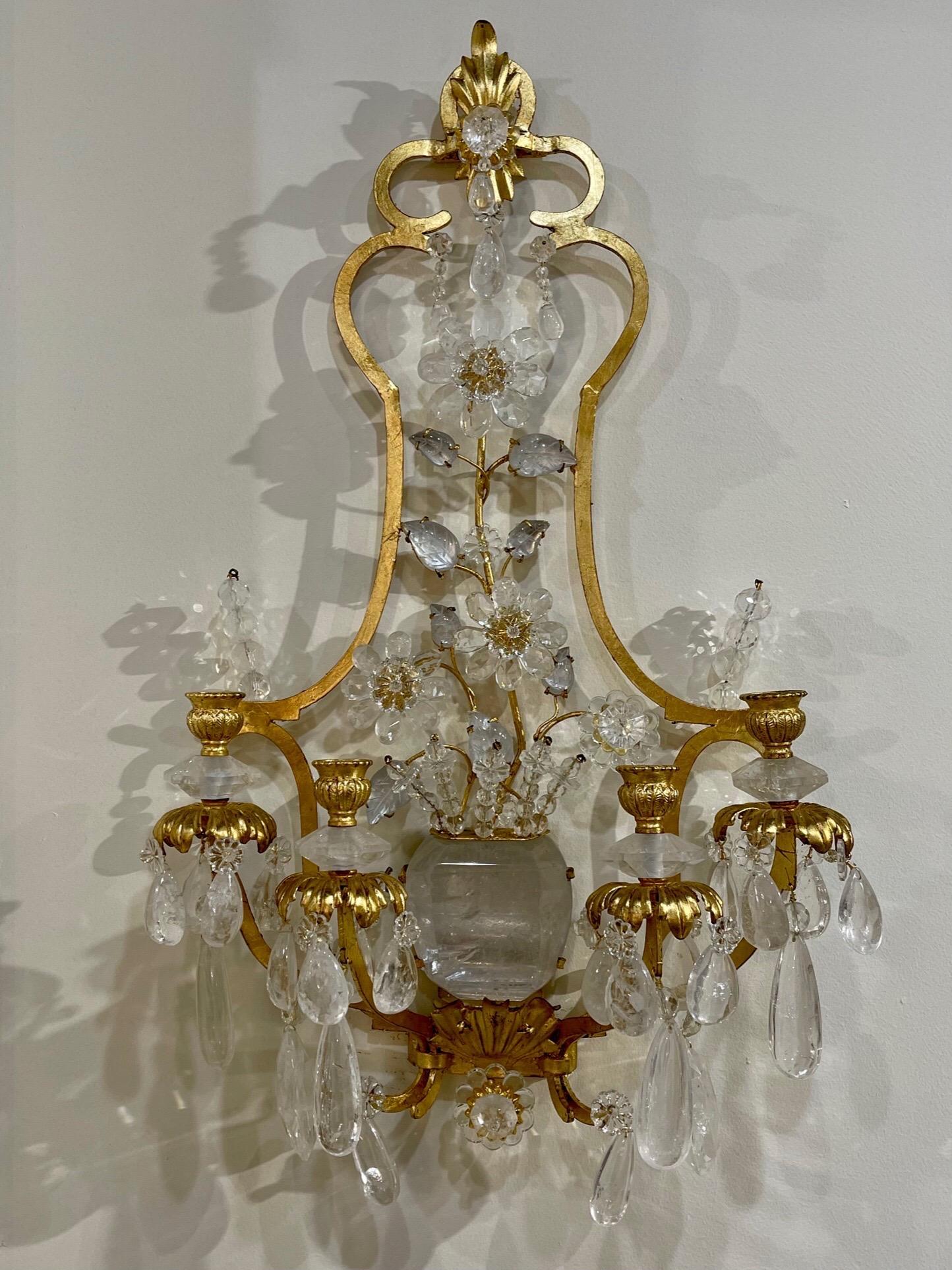 Exquisite pair of Italian Baguès style rock crystal and gilt metal sconces with 4 lights. Featuring gorgeous crystal flowers emerging from a rock crystal vase. Very special!