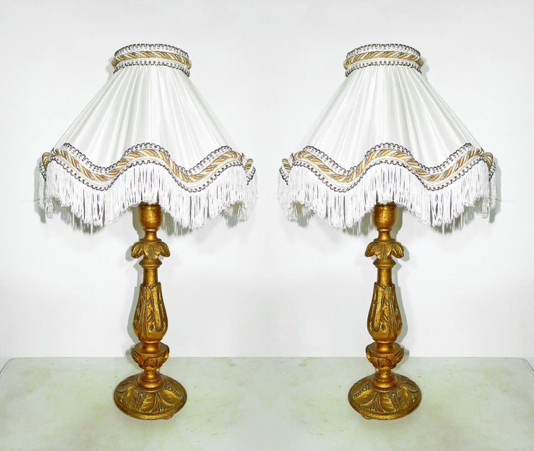 Pair of elegant Italian baroque carved giltwood candlesticks torchères turned into table lamps with ivory silk lampshades
Measures:
Height 24 in /60 cm
Diameter 14 in /36 cm
Weight 5 lb. /2,5 kg
Housing one light bulb each ( E14 )
Good working