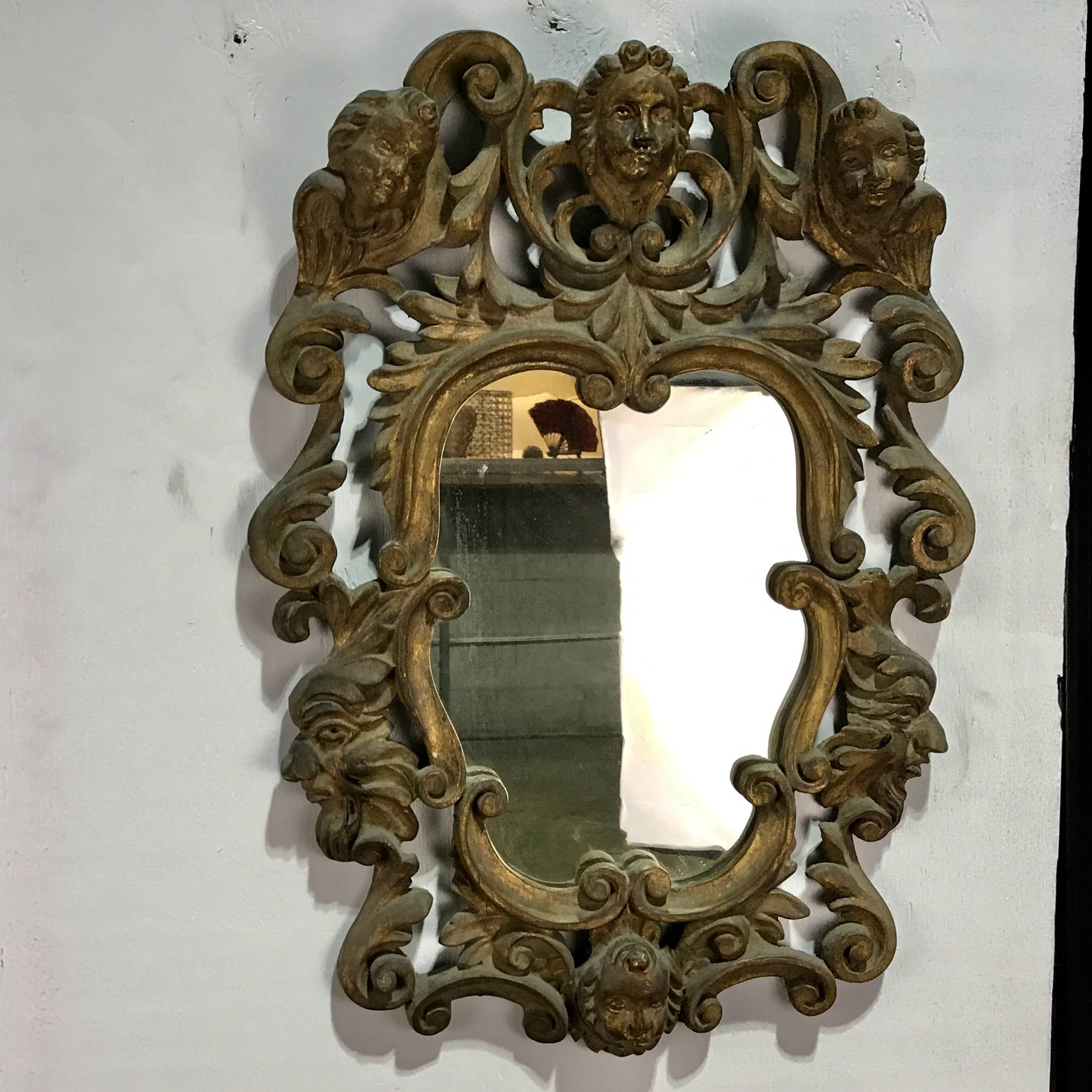 Pair of Italian Baroque carved wood mirrors, each one of cartouche form with elaborate carving and inset antique 14