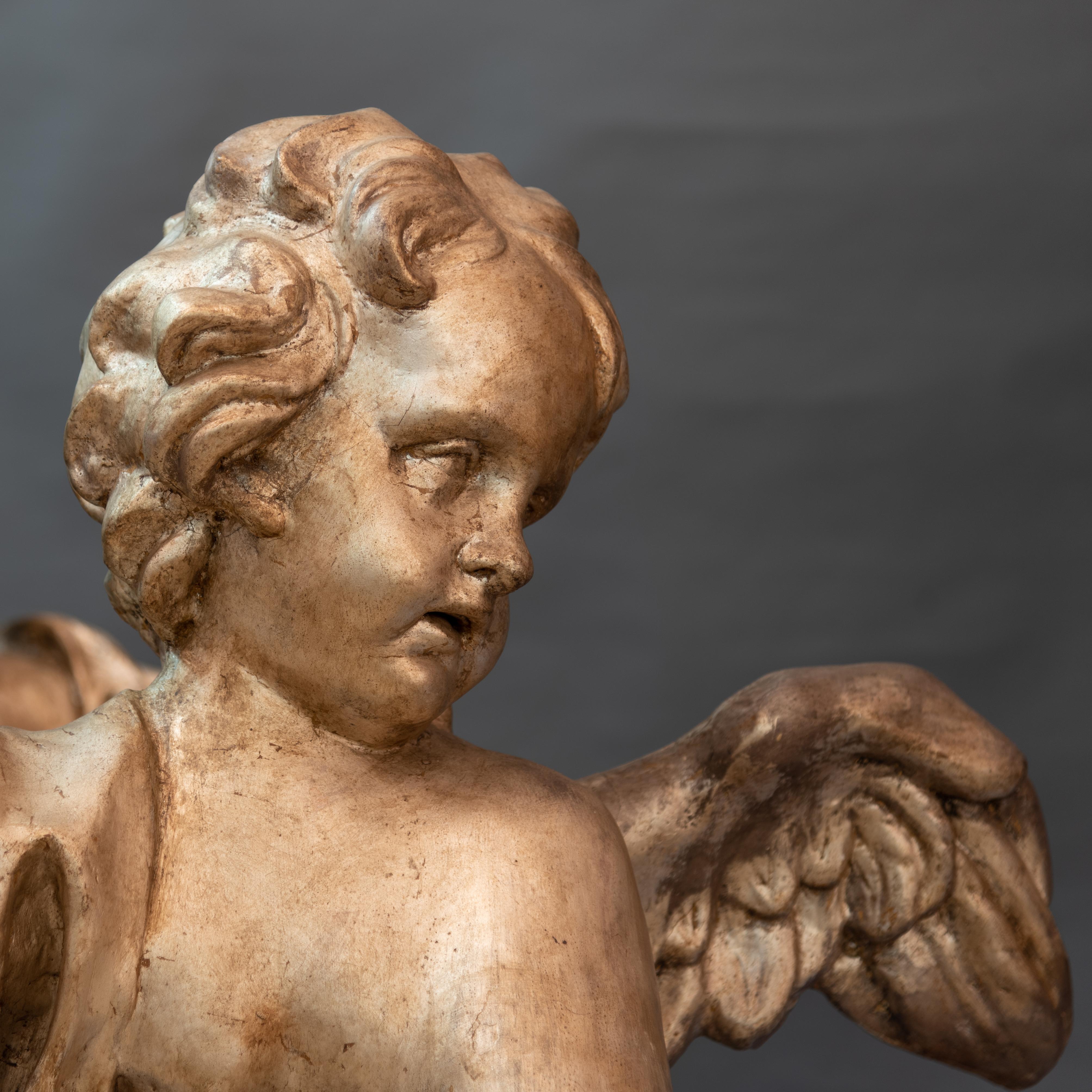 Pair of large angels, mecca silver papier mâché
Florence, late Baroque period
Original bases in faux marble lacquered wood.

These pair of large angels are shipped from Rome,Italy. Under existing legislation, any artwork in Italy created over 70