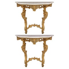 pair of Italian Baroque Period patinated wood and Carrara marble consoles