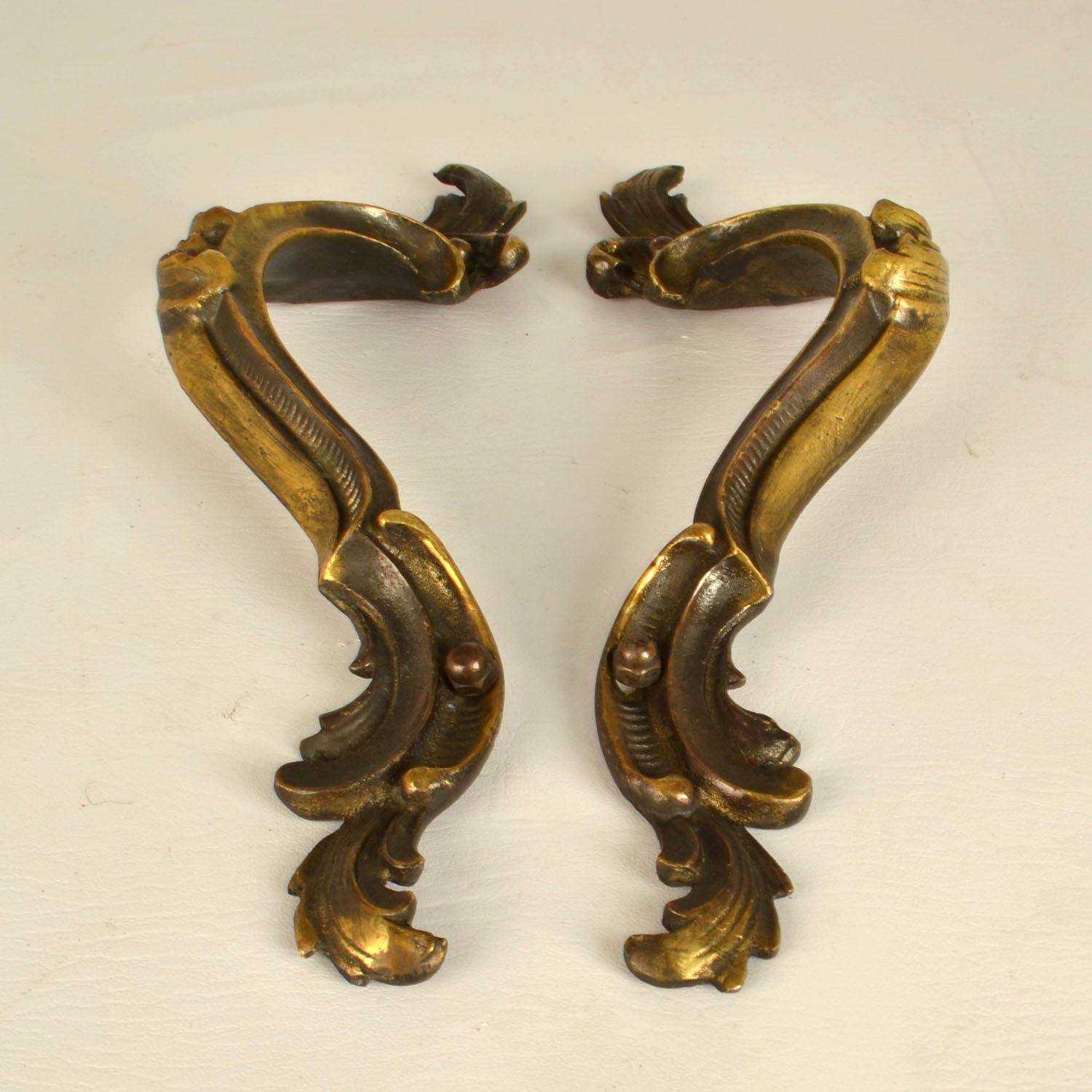 Two double Italian Baroque style push and pull bronze door handles with elaborate design and original patina. They are most likely made in the late 19th century but almost identical to the original 17th and early 18th century handles.
Baroque is a