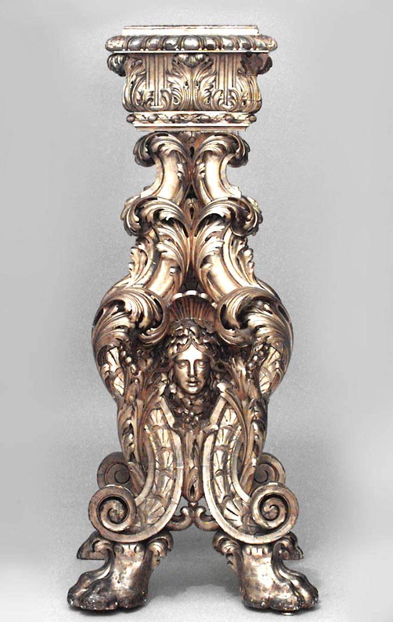 Pair of Italian Baroque style (Roman, 19th century) giltwood pedestals carved with heavy acanthus leaves above an Apollo mask on lions paw feet.
 